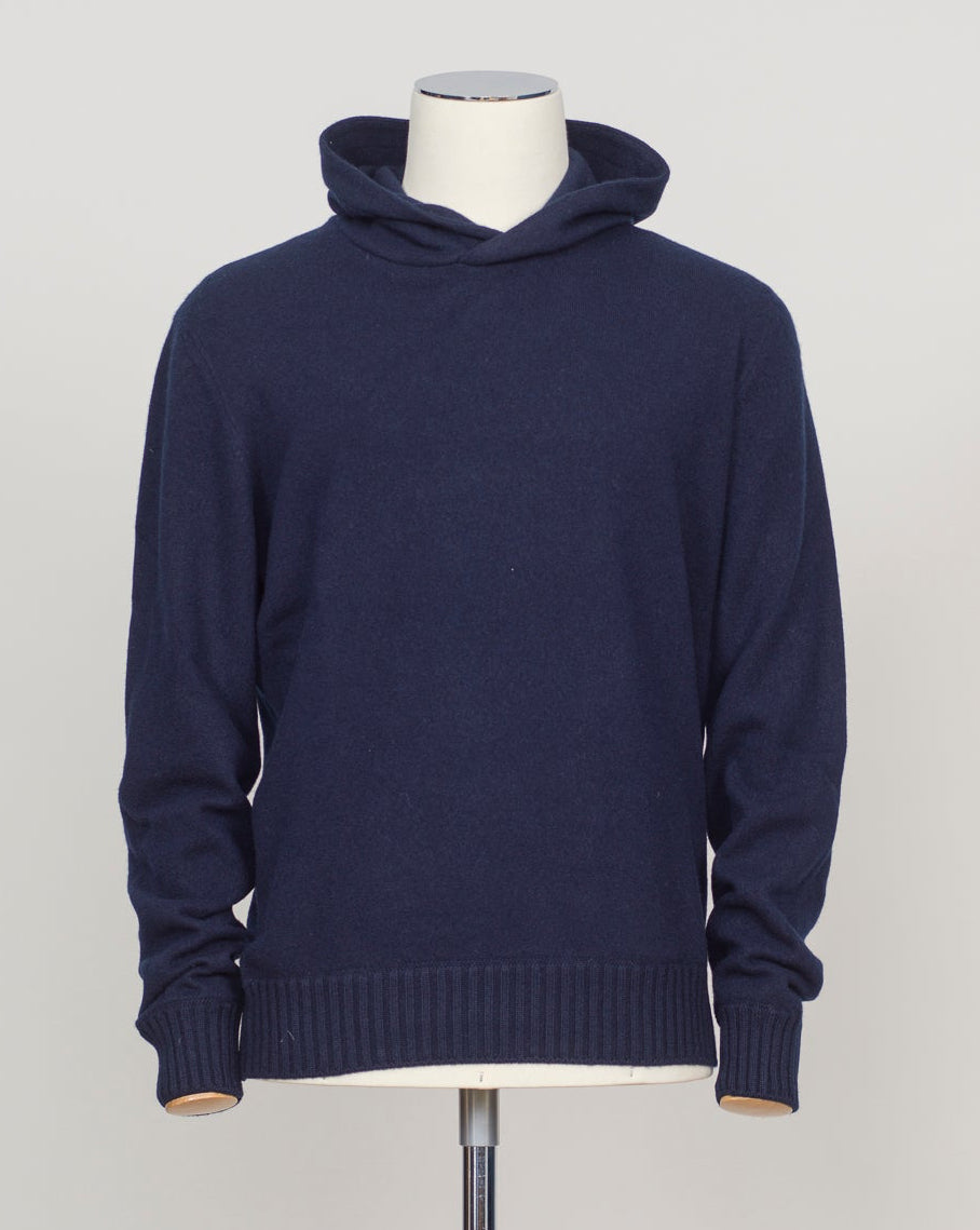 Luxurious felted cashmere hoodie in rich navy. Crafted by Gran Sasso with exceptional softness and weight. The relaxed silhouette provides comfortable layering over knitwear or worn alone. Perfect for refined casual wear that bridges seasons. Gran Sasso Felted Cashmere Hoodie / Navy