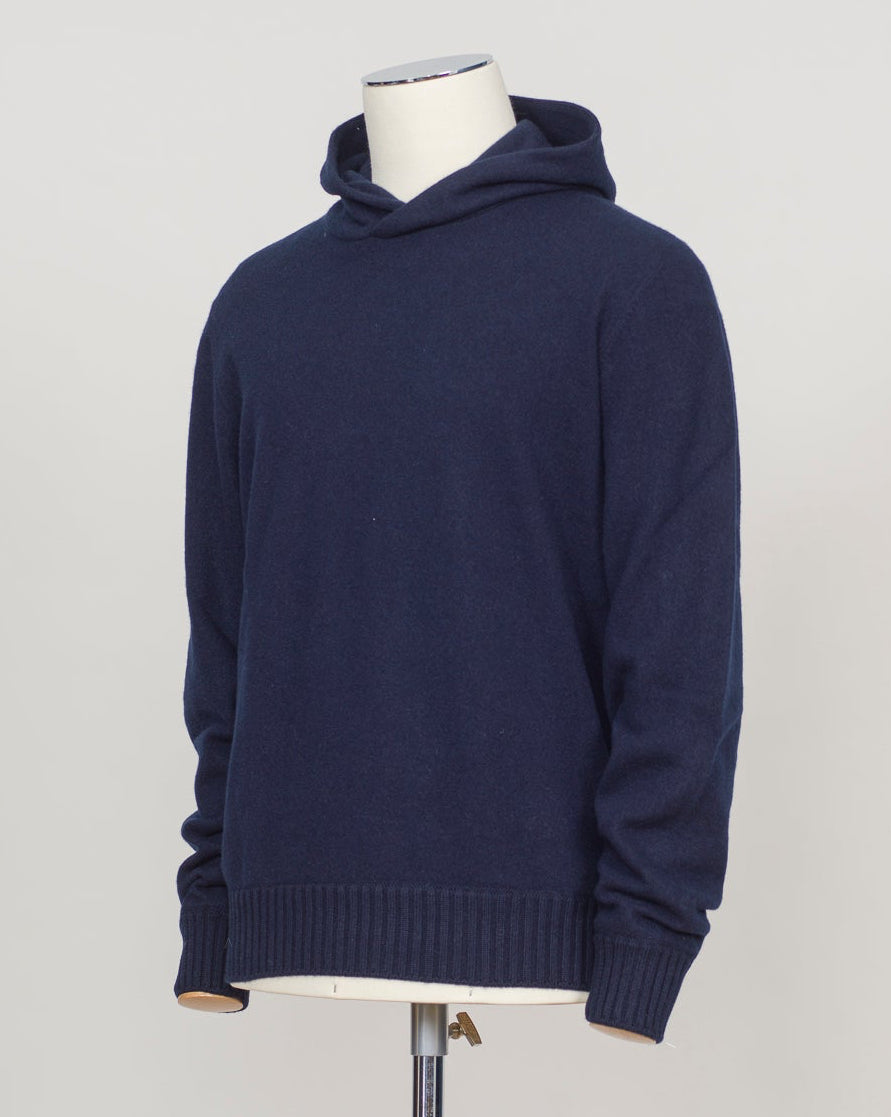Luxurious felted cashmere hoodie in rich navy. Crafted by Gran Sasso with exceptional softness and weight. The relaxed silhouette provides comfortable layering over knitwear or worn alone. Perfect for refined casual wear that bridges seasons. Gran Sasso Felted Cashmere Hoodie / Navy