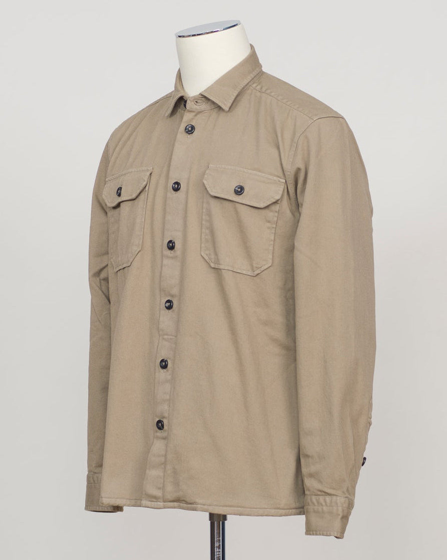 Ghirardelli Heavy Twill Overshirt / Taupe Heavy twill overshirt in taupe. Crafted from substantial cotton twill for durability and structure. Classic overshirt silhouette layers effortlessly over knitwear or worn standalone. Designed for refined casual wear and everyday versatility.