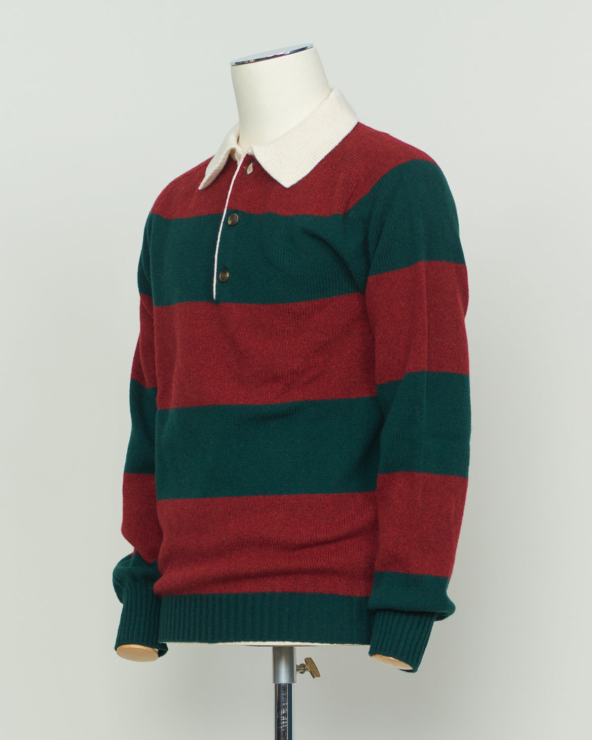 A timeless rugby polo crafted from pure wool by Harley of Scotland. The bold red and green striped pattern embodies classic Scottish heritage and collegiate charm. Structured knit construction delivers durability and shape retention, while the natural breathability of wool adapts to layering and seasonal transitions. Perfect for the discerning wearer who values authentic craftsmanship and understated sophistication.