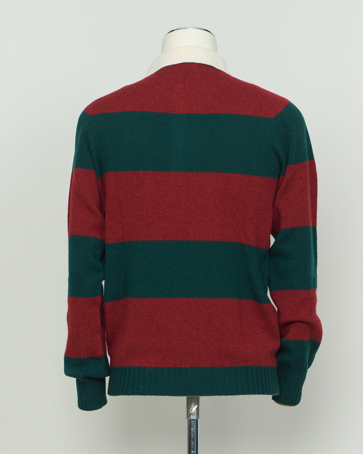 A timeless rugby polo crafted from pure wool by Harley of Scotland. The bold red and green striped pattern embodies classic Scottish heritage and collegiate charm. Structured knit construction delivers durability and shape retention, while the natural breathability of wool adapts to layering and seasonal transitions. Perfect for the discerning wearer who values authentic craftsmanship and understated sophistication.