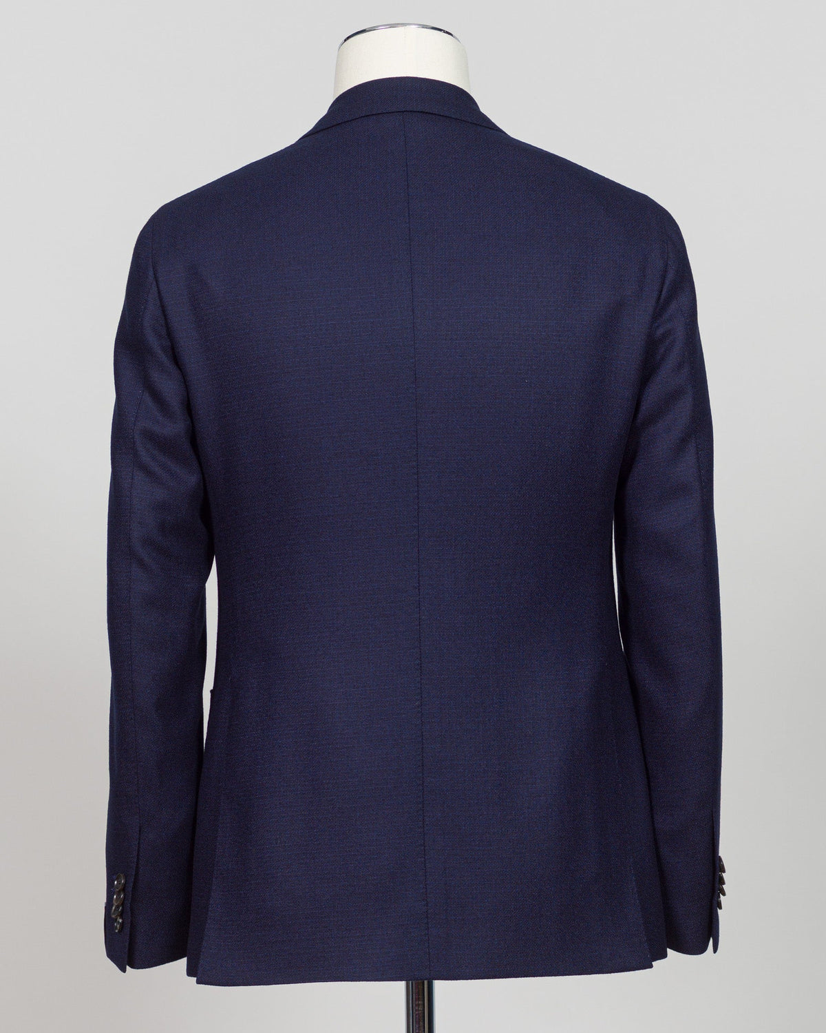 Caruso flannel sport jacket crafted in navy wool with tailored precision. This versatile layer features refined construction detailing and a structured silhouette designed for sophisticated menswear styling. Soft woolen fabric offers warmth and texture while maintaining a polished appearance, making it an essential piece for layering across seasons. Ideal for both professional and casual refined occasions, this jacket pairs seamlessly with dress trousers, chinos, or tailored separates. The classic navy tone