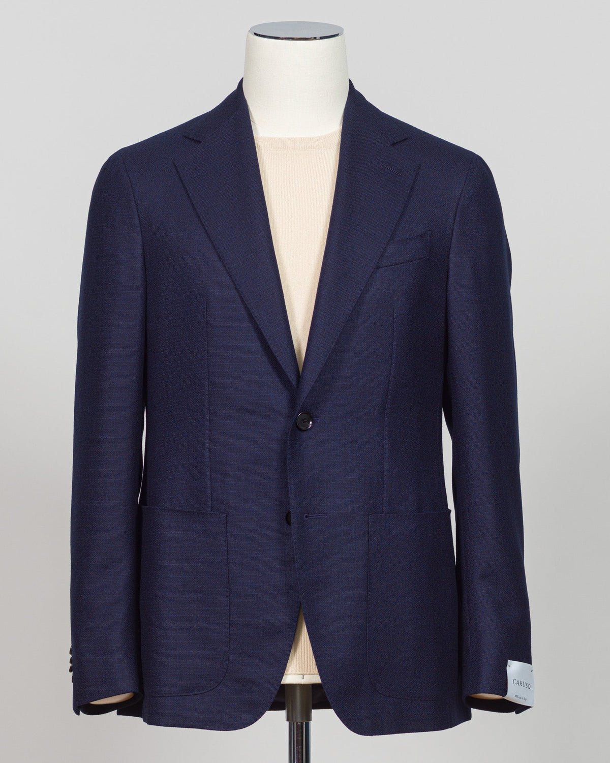 Caruso flannel sport jacket crafted in navy wool with tailored precision. This versatile layer features refined construction detailing and a structured silhouette designed for sophisticated menswear styling. Soft woolen fabric offers warmth and texture while maintaining a polished appearance, making it an essential piece for layering across seasons. Ideal for both professional and casual refined occasions, this jacket pairs seamlessly with dress trousers, chinos, or tailored separates. The classic navy tone