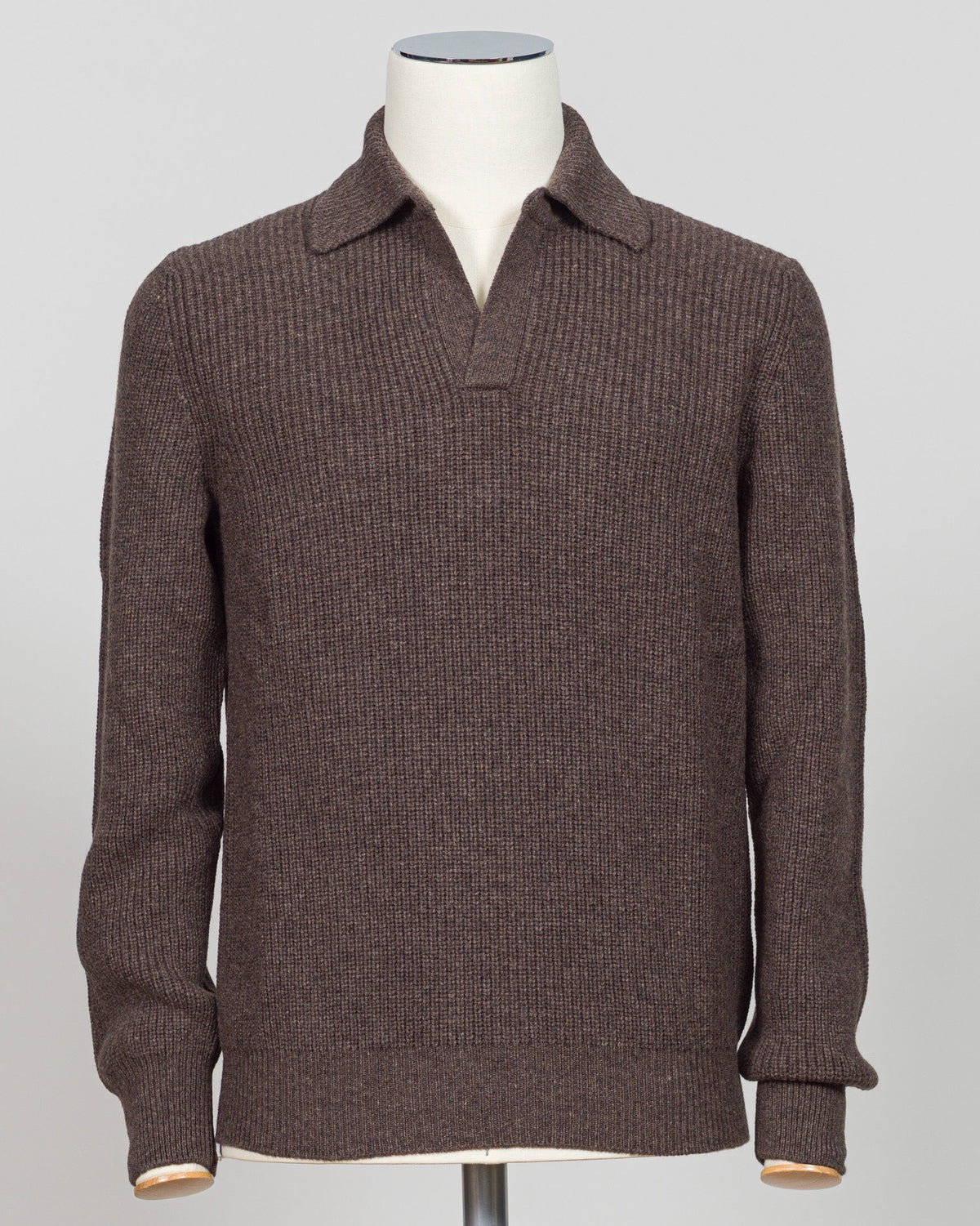 A dark brown ribbed knit polo sweater displayed on a white mannequin torso against a light gray background. A refined ribbed polo in deep brown. Gran Sasso's signature knit construction offers subtle texture and timeless appeal. Perfect layered or worn alone for effortless sophistication. Gran Sasso Ribbed Polo / Brown