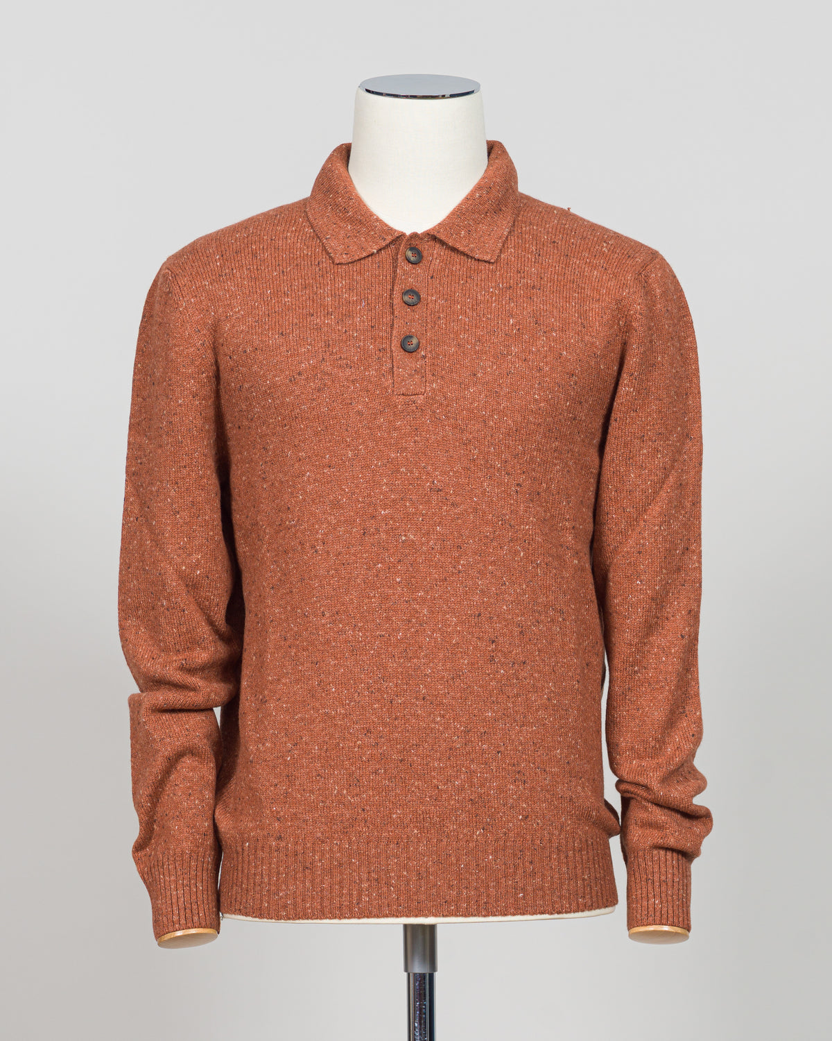 A timeless polo crafted from luxurious Donegal yarn, blending Italian heritage with understated elegance. The textured weave creates subtle visual interest while maintaining the versatility of a classic orange foundation. Refined construction and premium materials make this piece equally at home in casual settings or layered for sophisticated warmth. A staple worthy of investment.