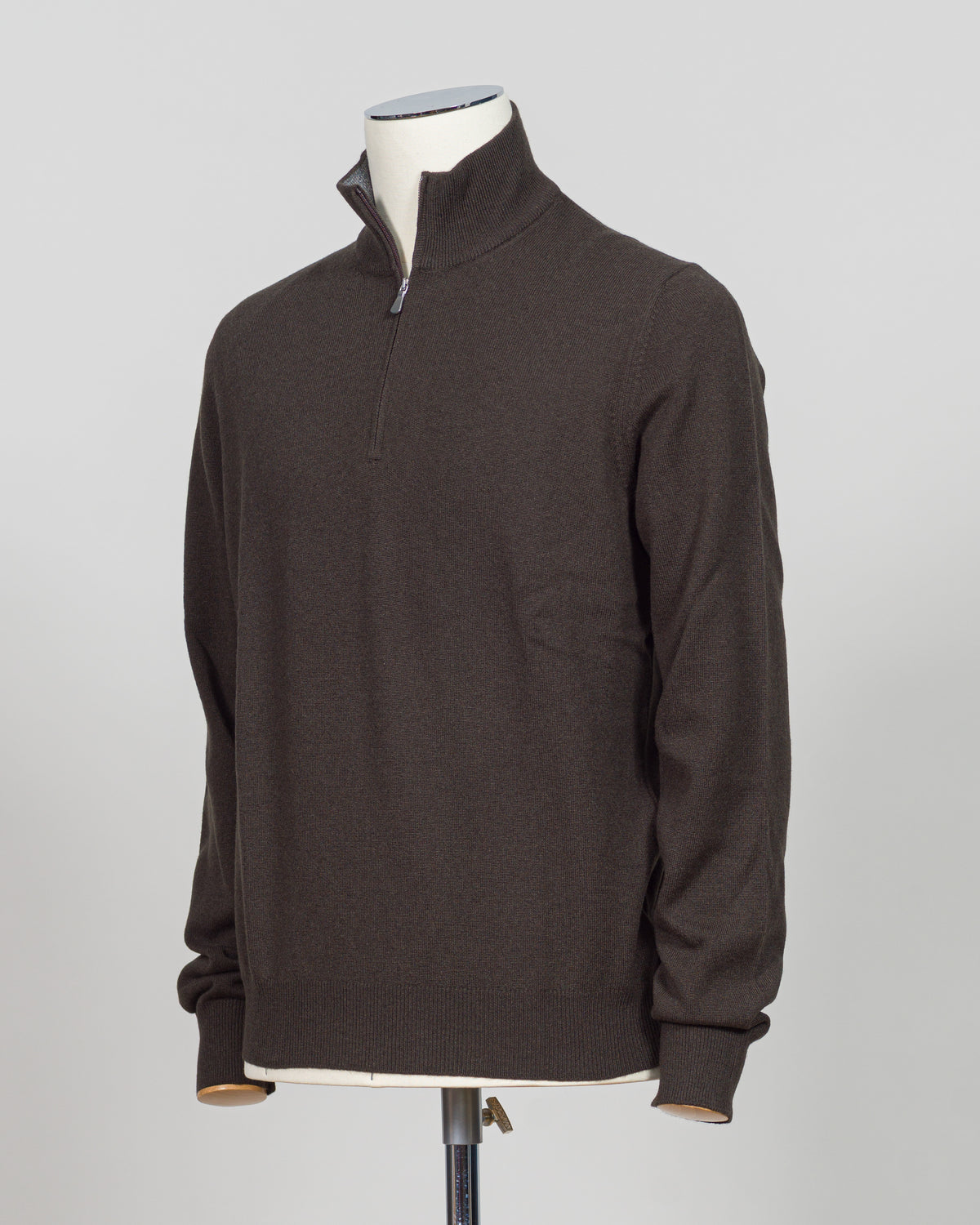 Gran Sasso Half-Zip Knit in rich dark brown, a timeless layering essential for the refined wardrobe. This Italian-crafted piece offers sophisticated simplicity with a comfortable half-zip construction, perfect for transitional styling. The knit's subtle texture and classic colorway pair effortlessly with tailored trousers or casual wear. Expertly finished with attention to detail throughout, this sweater delivers understated elegance and versatility season after season.