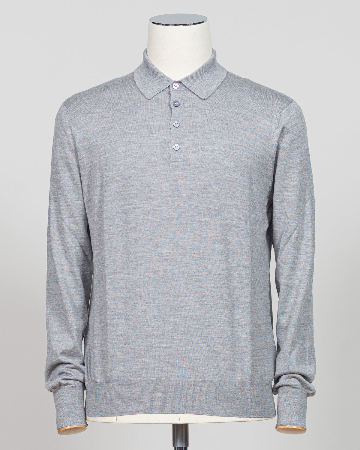 Refined elegance meets tactile luxury in this Gran Sasso polo, crafted from a sophisticated blend of wool, cashmere, and silk. The silver tone offers understated versatility across seasons, while the premium fiber composition delivers exceptional softness and breathability. A timeless essential for the discerning wardrobe. Gran Sasso Wool Cashmere & Silk Polo / Silver