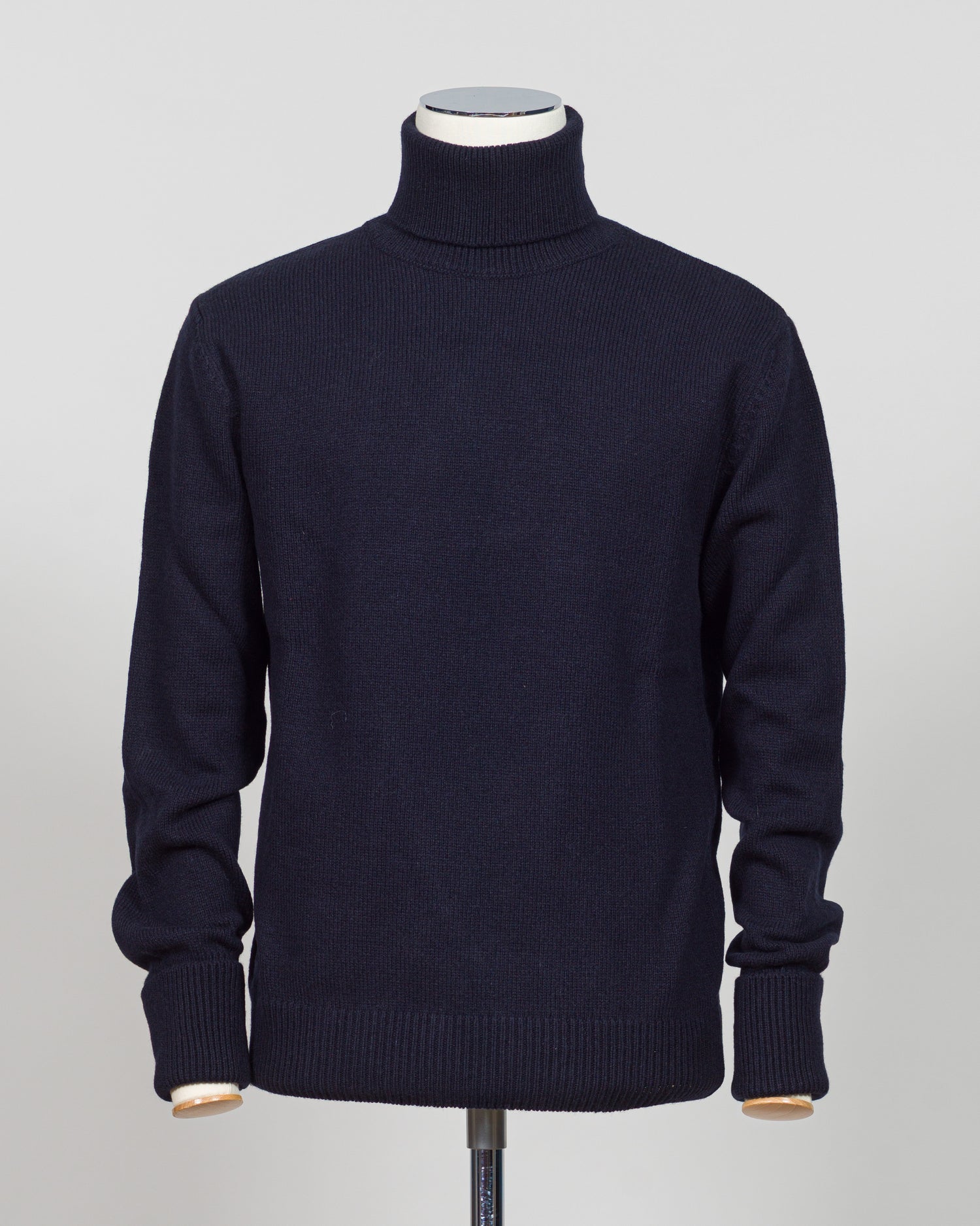 Crafted from premium Italian yarn, the G.R.P. Firenze rollneck knit delivers refined simplicity with architectural precision. The navy tone pairs seamlessly with tailored pieces, while the structured rollneck and clean finish reflect the meticulous construction standards of contemporary menswear. Ideal for layering or worn as a statement piece, this knit bridges casual elegance with wardrobing versatility.