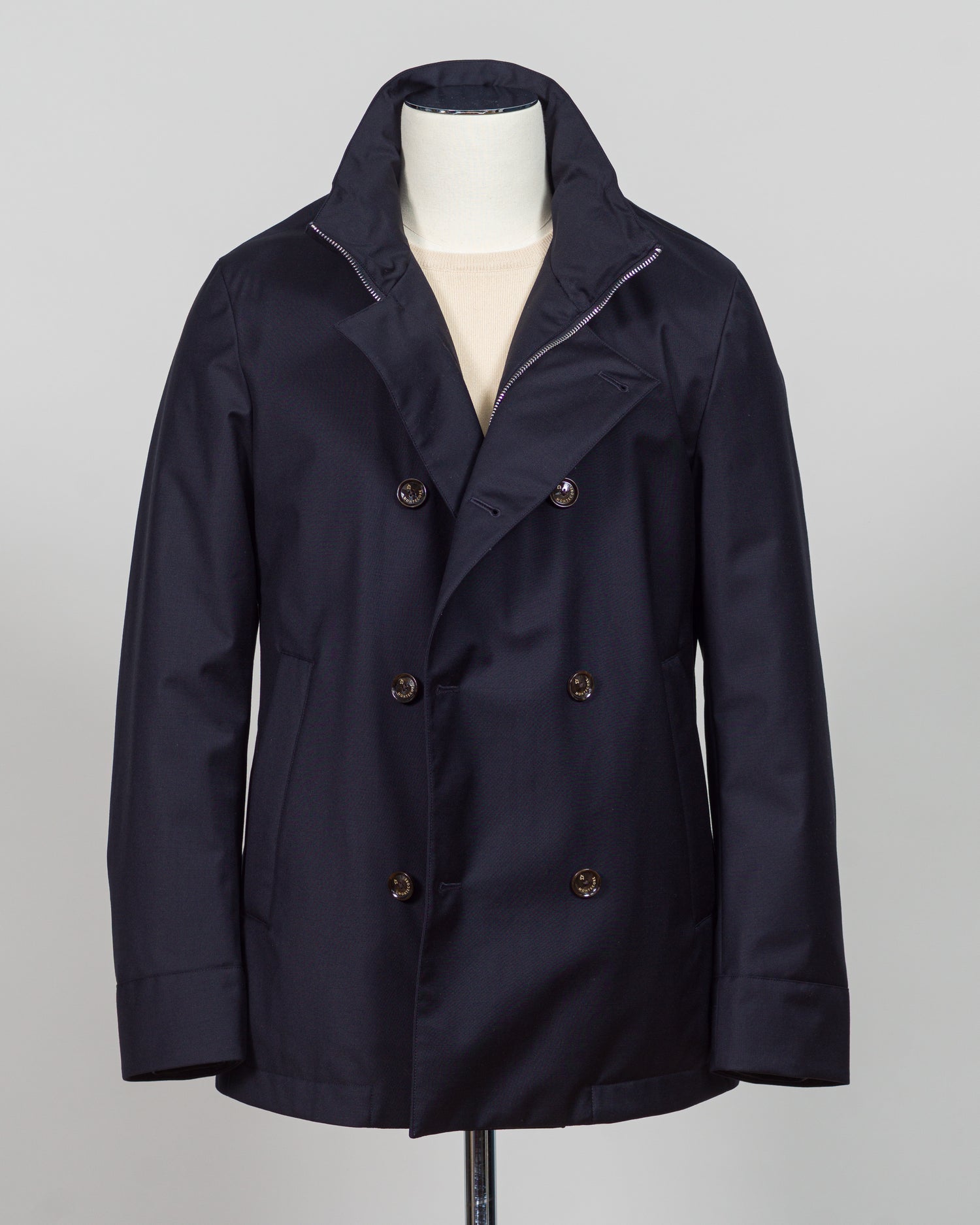 Montecore's double-breasted down jacket combines Italian tailoring precision with practical outerwear design. Navy wool outer with premium down filling delivers warmth without bulk, while structured shoulders and clean lines reflect luxury menswear craftsmanship. Horn buttons and internal quilting detail elevate everyday wear.
Perfect for layering across seasons—wear over knitwear or dress shirts. The relaxed yet refined silhouette suits both smart-casual and dressier occasions. Wind and water-resistant fi