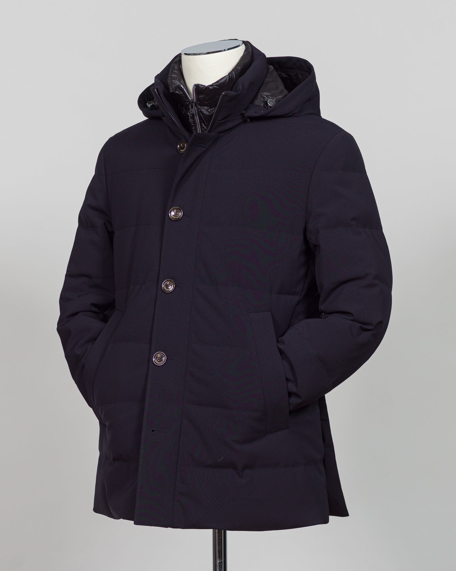 The Montecore Aerotwill Down Jacket combines lightweight insulation with weather-resistant performance. Crafted from premium aerotwill fabric, this navy jacket traps warmth without bulk, making it ideal for layering through transitional seasons or wearing as a standalone piece in mild conditions. The down fill provides responsive loft and compressibility for easy packing and storage. Cut with a refined silhouette that works seamlessly with tailored pieces, this jacket bridges casual functionality and polish