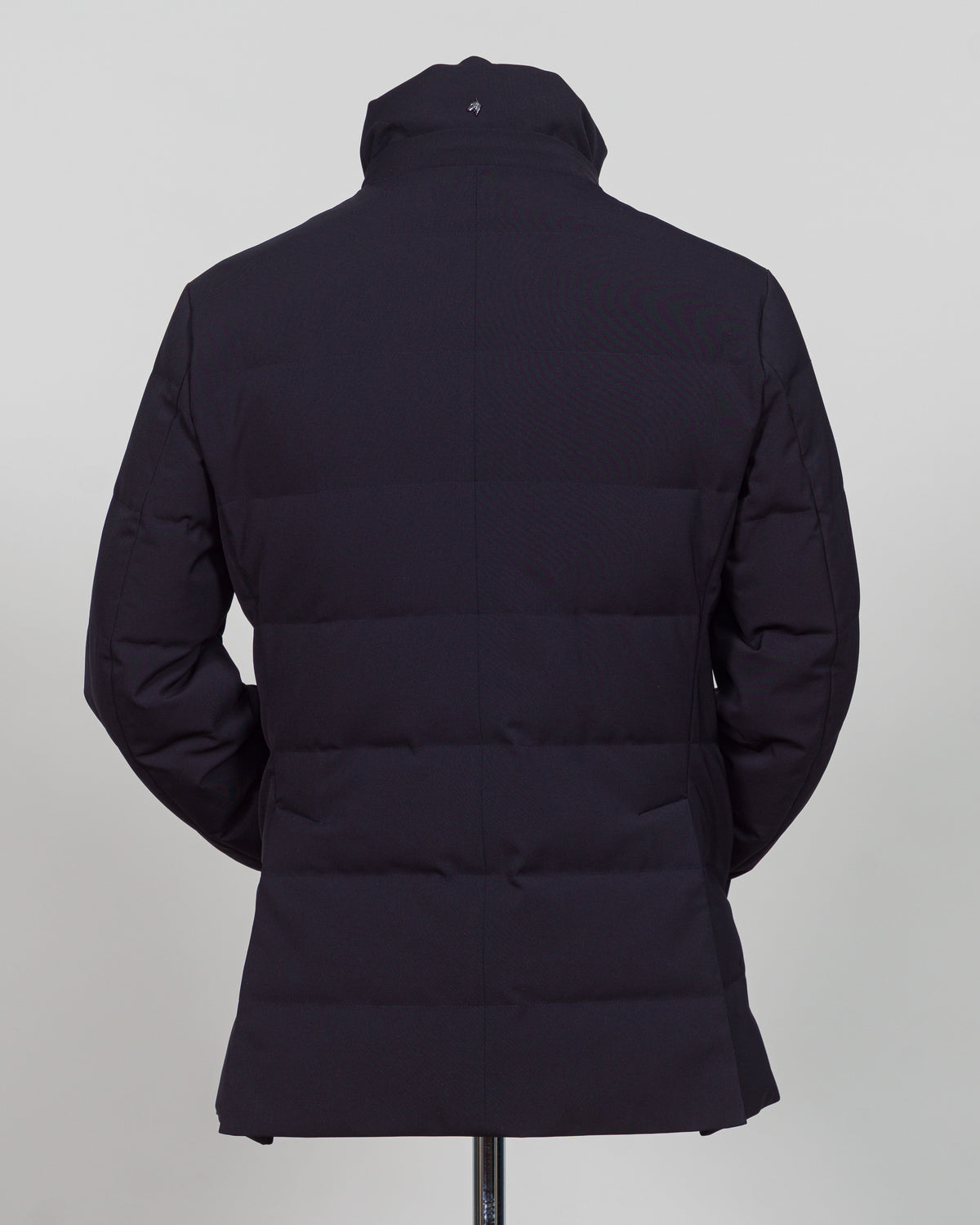 The Montecore Aerotwill Down Jacket combines lightweight insulation with weather-resistant performance. Crafted from premium aerotwill fabric, this navy jacket traps warmth without bulk, making it ideal for layering through transitional seasons or wearing as a standalone piece in mild conditions. The down fill provides responsive loft and compressibility for easy packing and storage. Cut with a refined silhouette that works seamlessly with tailored pieces, this jacket bridges casual functionality and polish