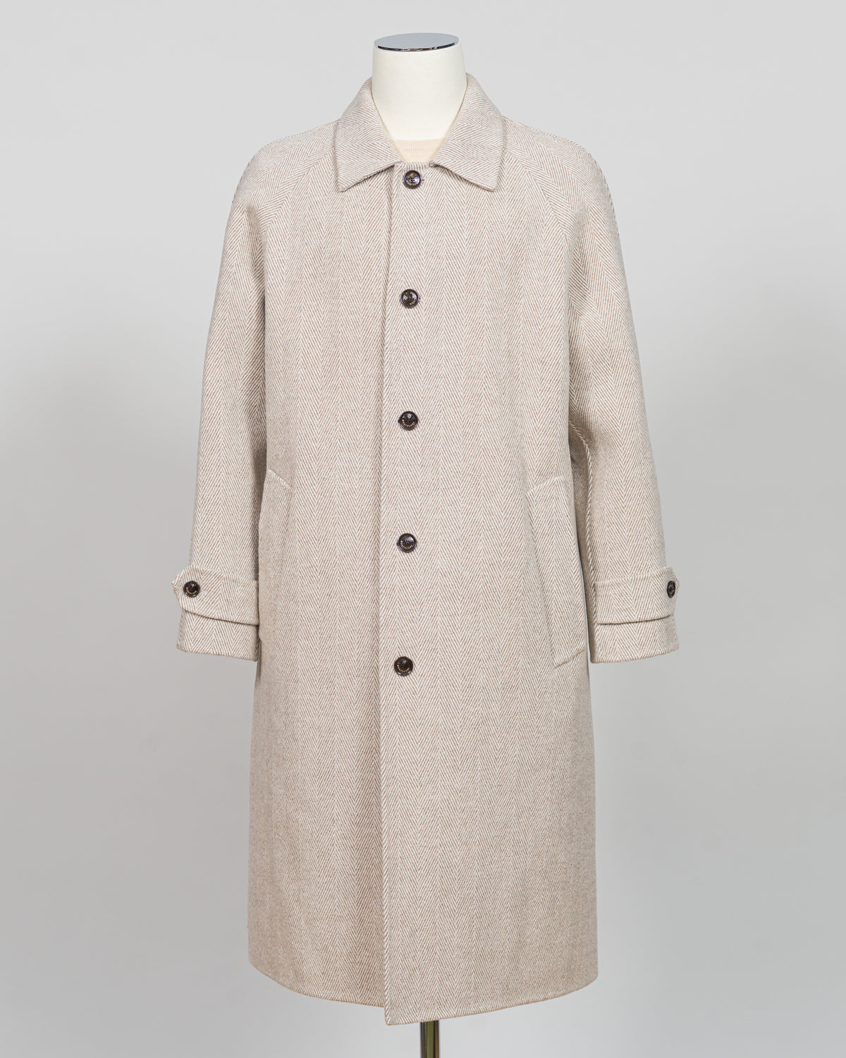 A light beige textured wool coat displayed on a mannequin against a neutral light gray background.