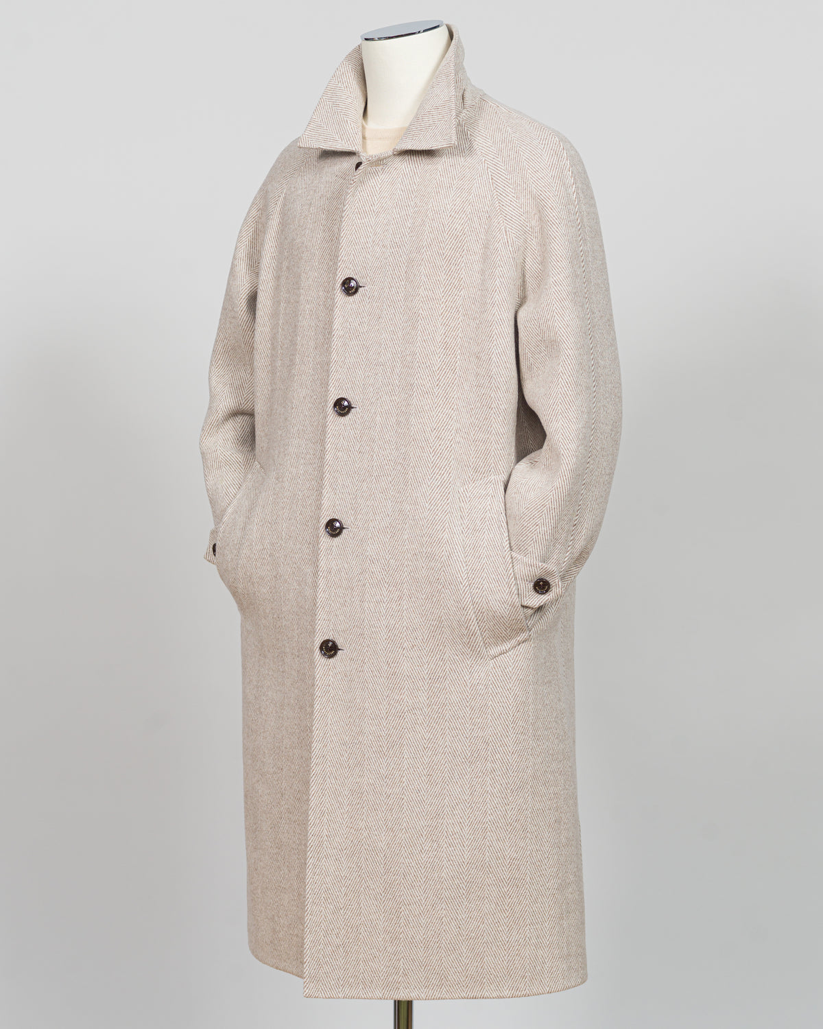 A light beige textured wool-blend coat displayed on a mannequin against a neutral gray background.