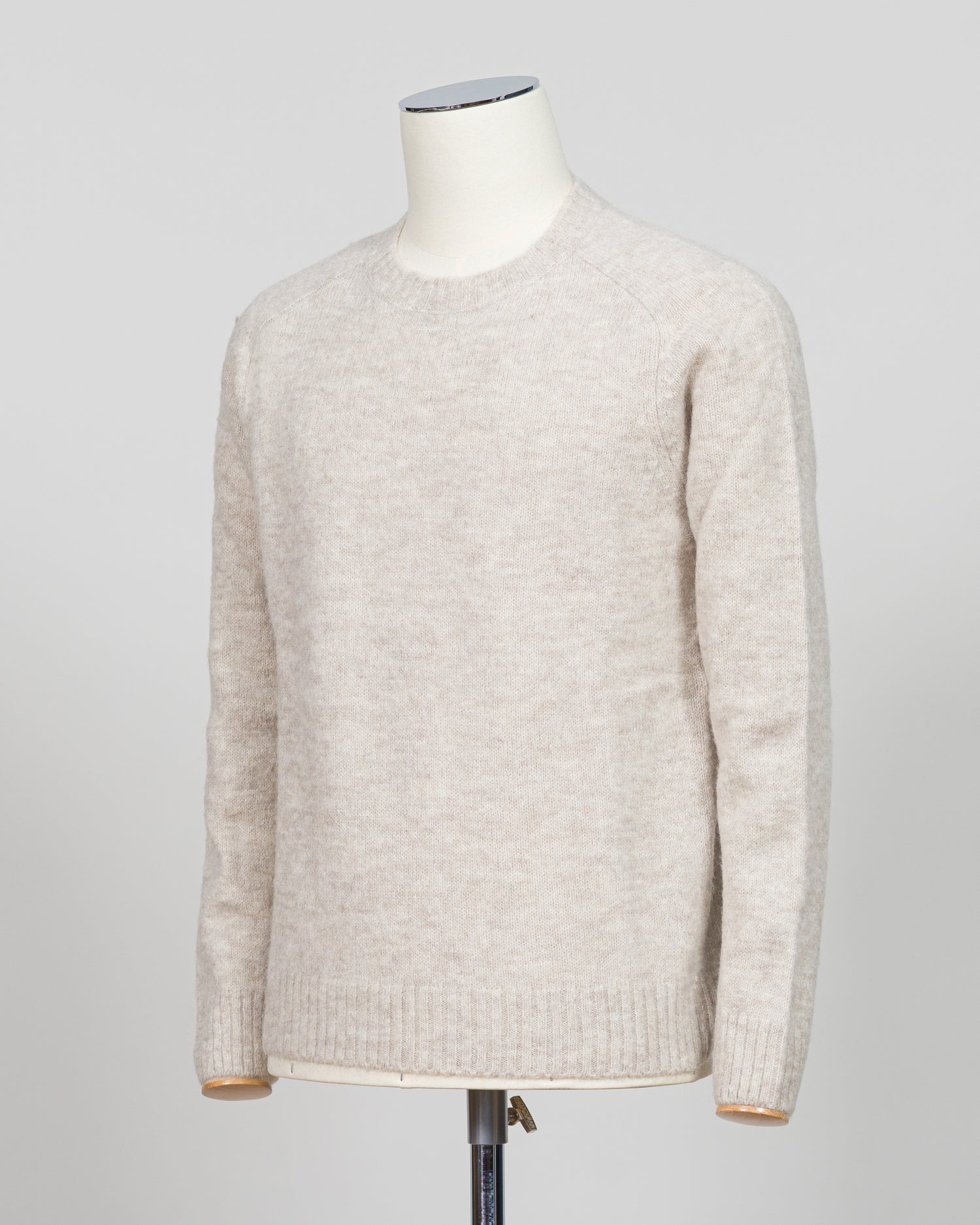 Effortless layering meets understated elegance with the FLY3 Raglan Crewneck Knit. The classic raglan silhouette drapes naturally across the shoulders, creating a relaxed fit that works equally well over a crisp dress shirt or worn solo. Crafted in a neutral oatmeal tone, this piece anchors any wardrobe—from business casual to weekend wear. The crew neckline and premium knit construction ensure lasting comfort and durability, making it a versatile staple for year-round styling.