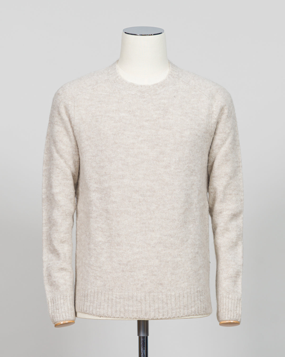 Effortless layering meets understated elegance with the FLY3 Raglan Crewneck Knit. The classic raglan silhouette drapes naturally across the shoulders, creating a relaxed fit that works equally well over a crisp dress shirt or worn solo. Crafted in a neutral oatmeal tone, this piece anchors any wardrobe—from business casual to weekend wear. The crew neckline and premium knit construction ensure lasting comfort and durability, making it a versatile staple for year-round styling.