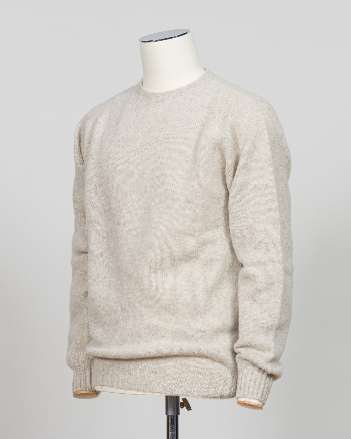Harley of Scotland's iconic shaggy crew neck sweater in basalt. Hand-knitted using traditional Scottish techniques, this piece features a distinctive textured surface that catches light beautifully while delivering exceptional softness against the skin. The relaxed crew neck silhouette works seamlessly as a standalone layer or under tailored blazers for refined versatility.
Premium wool construction provides natural warmth and breathability across seasons. The generous shag pile creates visual depth and ta
