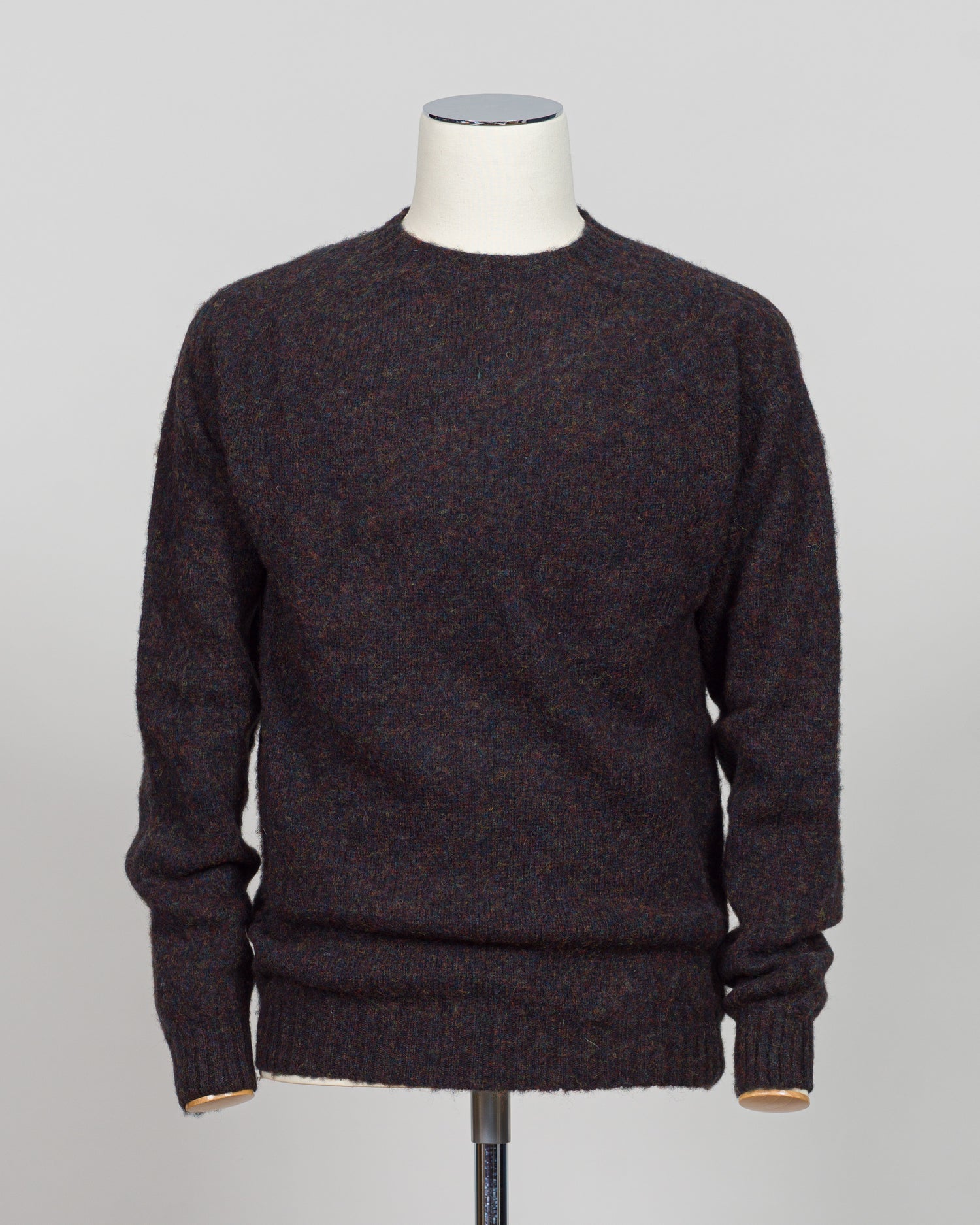 Harley of Scotland's iconic shaggy crew neck sweater in volcano. Hand-knitted using traditional Scottish techniques, this piece features a distinctive textured surface that catches light beautifully while delivering exceptional softness against the skin. The relaxed crew neck silhouette works seamlessly as a standalone layer or under tailored blazers for refined versatility.
Premium wool construction provides natural warmth and breathability across seasons. The generous shag pile creates visual depth and t