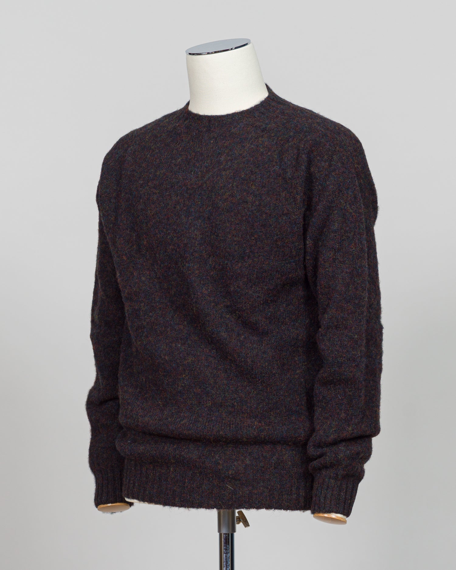 Harley of Scotland's iconic shaggy crew neck sweater in volcano. Hand-knitted using traditional Scottish techniques, this piece features a distinctive textured surface that catches light beautifully while delivering exceptional softness against the skin. The relaxed crew neck silhouette works seamlessly as a standalone layer or under tailored blazers for refined versatility.
Premium wool construction provides natural warmth and breathability across seasons. The generous shag pile creates visual depth and t