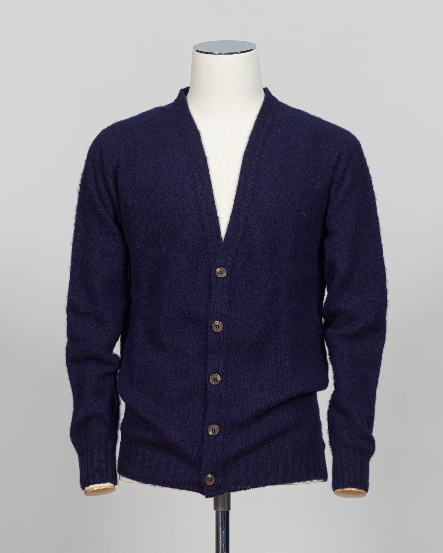 A timeless shaggy cardigan from Harley of Scotland, crafted in luxurious navy wool. This investment piece features a distinctive textured knit that adds depth and character to any wardrobe. Perfect for layering over shirts or wearing as a standalone statement, it delivers the rugged sophistication that defines Scottish knitwear heritage. The relaxed fit and substantial construction ensure years of wear, making it an essential addition to a refined menswear collection.
