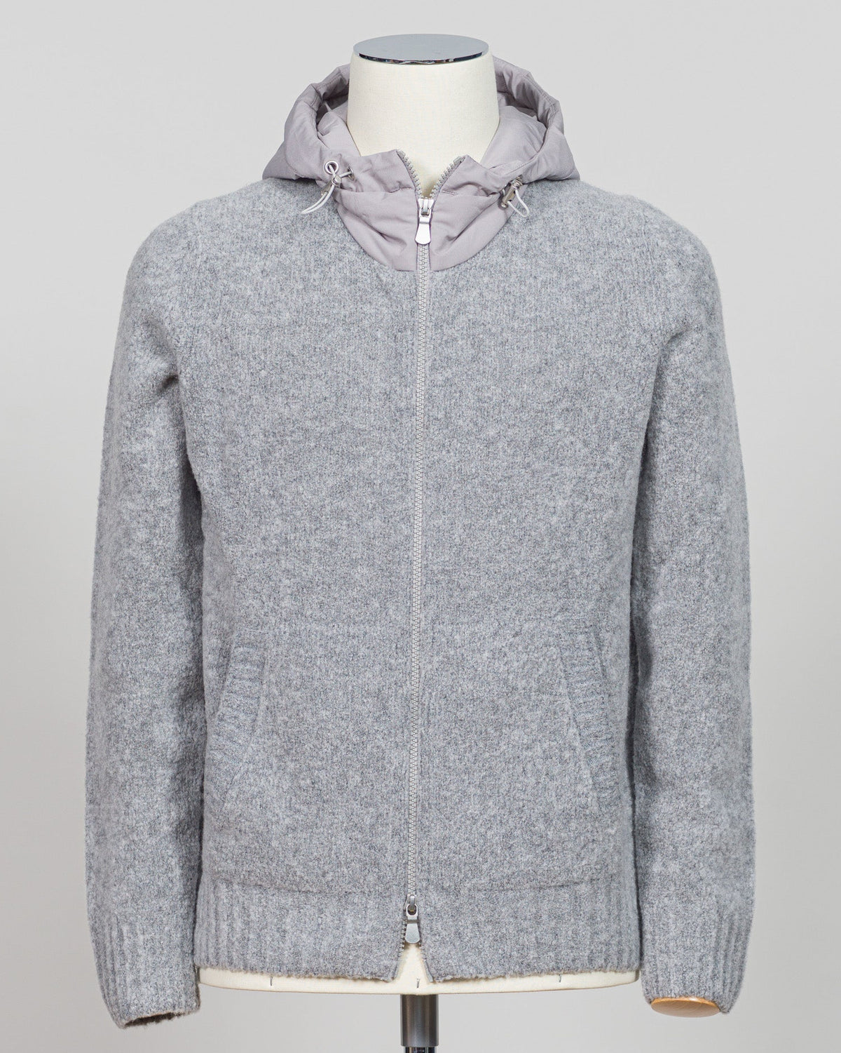 A relaxed layering essential in sumptuous bouclé knit. Gran Sasso's full-zip hoodie bridges the gap between structured knitwear and effortless comfort—perfect for weekend dressing or layering over basics. The light grey tone pairs seamlessly with tailored trousers or casual denim. Italian craftsmanship meets approachable luxury in a piece that works as hard as you do. Gran Sasso Full-Zip Bouclé Hoodie / Light Grey