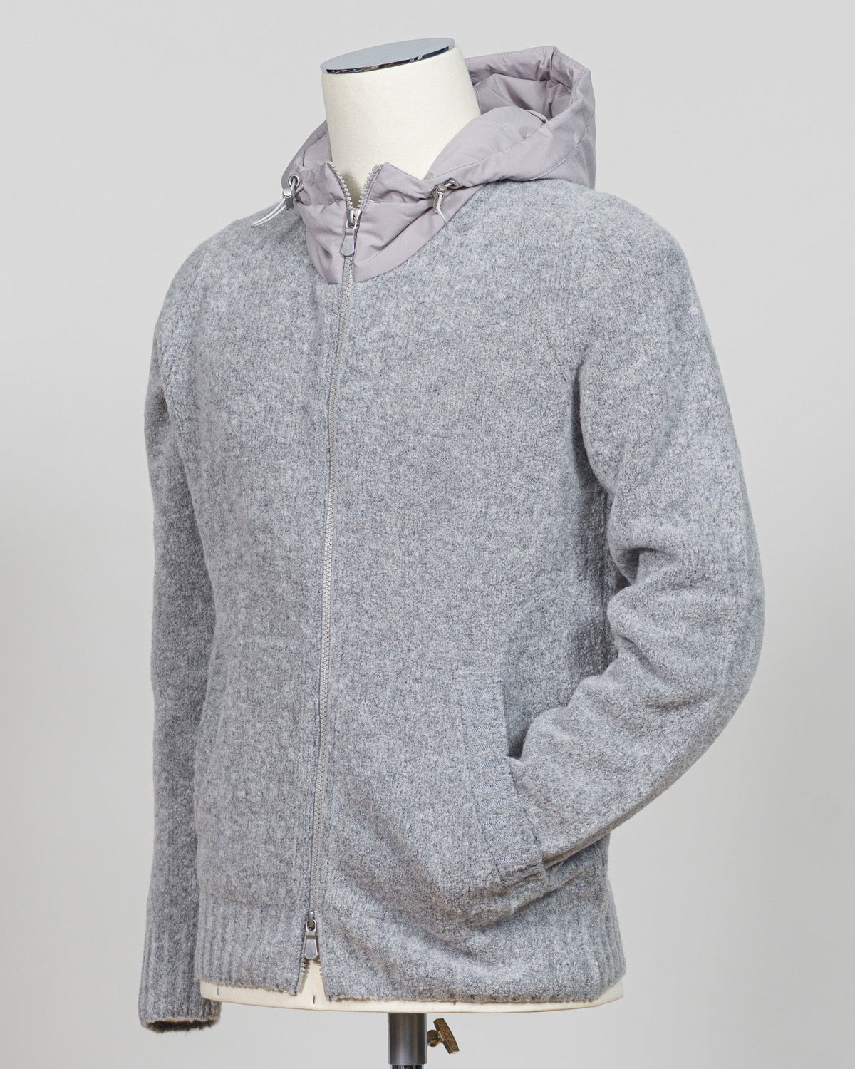 A relaxed layering essential in sumptuous bouclé knit. Gran Sasso's full-zip hoodie bridges the gap between structured knitwear and effortless comfort—perfect for weekend dressing or layering over basics. The light grey tone pairs seamlessly with tailored trousers or casual denim. Italian craftsmanship meets approachable luxury in a piece that works as hard as you do. Gran Sasso Full-Zip Bouclé Hoodie / Light Grey