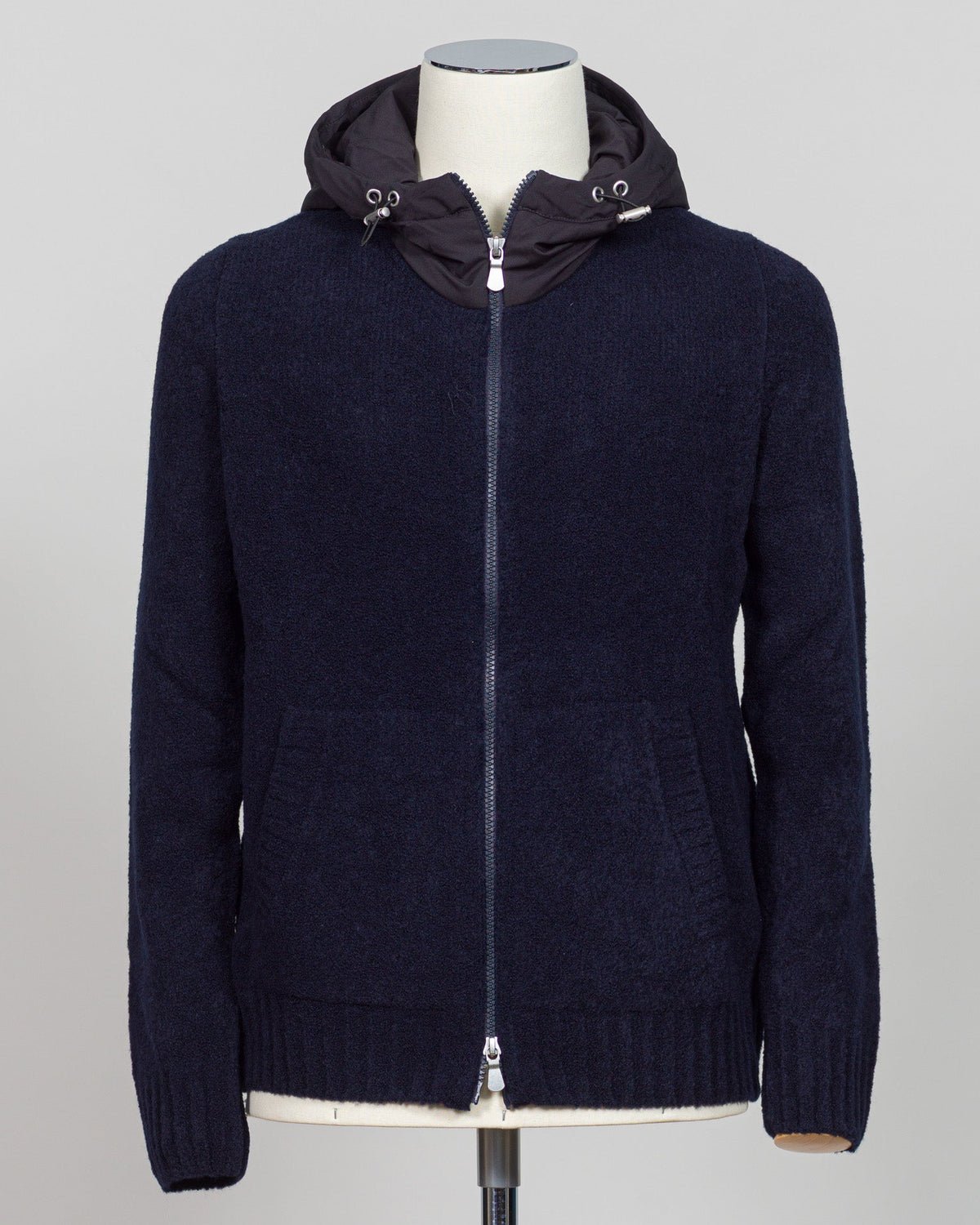 Luxurious bouclé knit in a refined navy shade. Full-zip construction with a relaxed fit ideal for layering or standalone wear. Crafted from premium Italian yarn for exceptional texture and durability. A versatile essential that bridges casual and sophisticated styling. Gran Sasso Full-Zip Bouclé Hoodie / Navy