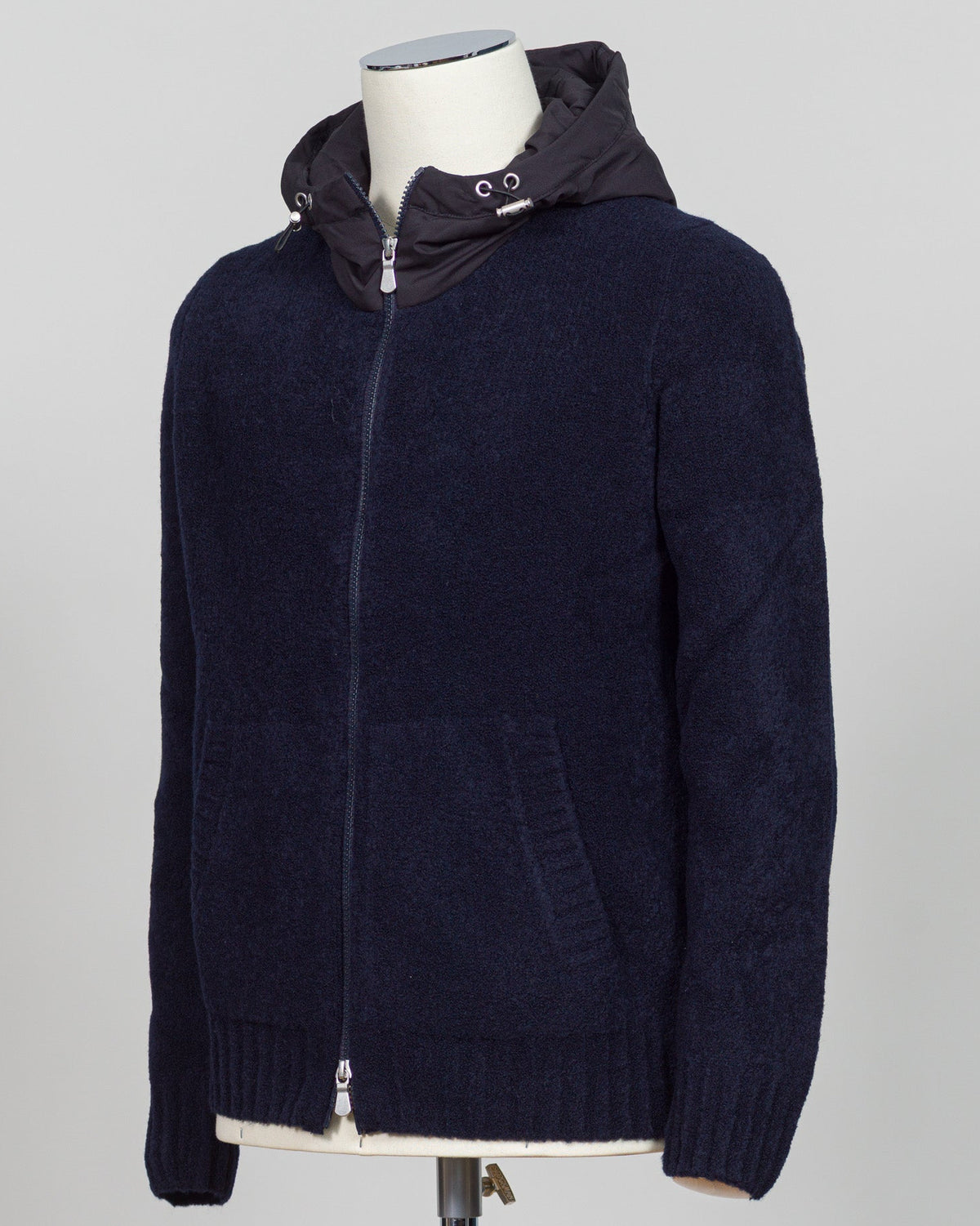 Luxurious bouclé knit in a refined navy shade. Full-zip construction with a relaxed fit ideal for layering or standalone wear. Crafted from premium Italian yarn for exceptional texture and durability. A versatile essential that bridges casual and sophisticated styling. Gran Sasso Full-Zip Bouclé Hoodie / Navy