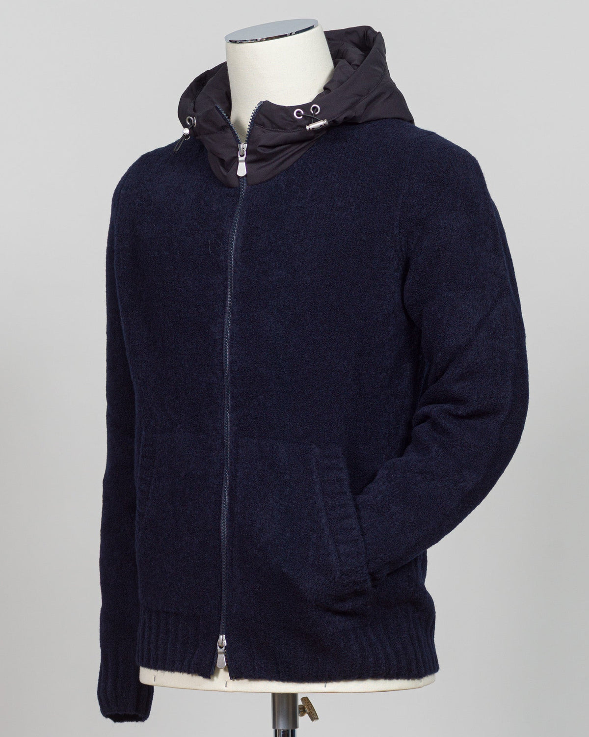 Luxurious bouclé knit in a refined navy shade. Full-zip construction with a relaxed fit ideal for layering or standalone wear. Crafted from premium Italian yarn for exceptional texture and durability. A versatile essential that bridges casual and sophisticated styling. Gran Sasso Full-Zip Bouclé Hoodie / Navy