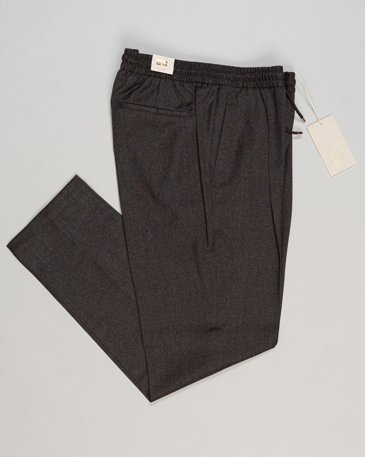 Refined Italian tailoring meets relaxed elegance. Briglia's drawstring flannel trousers deliver understated sophistication—structured yet forgiving, with a fluid drape that works across seasons. The soft flannel fabric ages beautifully, while the adjustable waist ensures a personalized fit. A versatile foundation for refined casual wardrobes. Briglia Drawstring Flannel Trousers / Brown