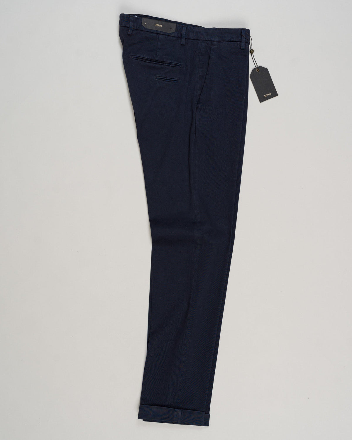 Briglia's garment-dyed cotton chinos deliver understated Italian craftsmanship in a versatile navy that pairs effortlessly with any wardrobe. The soft, pre-washed cotton develops character with wear, offering a relaxed yet refined silhouette perfect for both casual weekends and smart-casual occasions. Premium construction and attention to detail make these a timeless staple for the discerning gentleman. Briglia Garment Dyed Cotton Chinos / Navy
