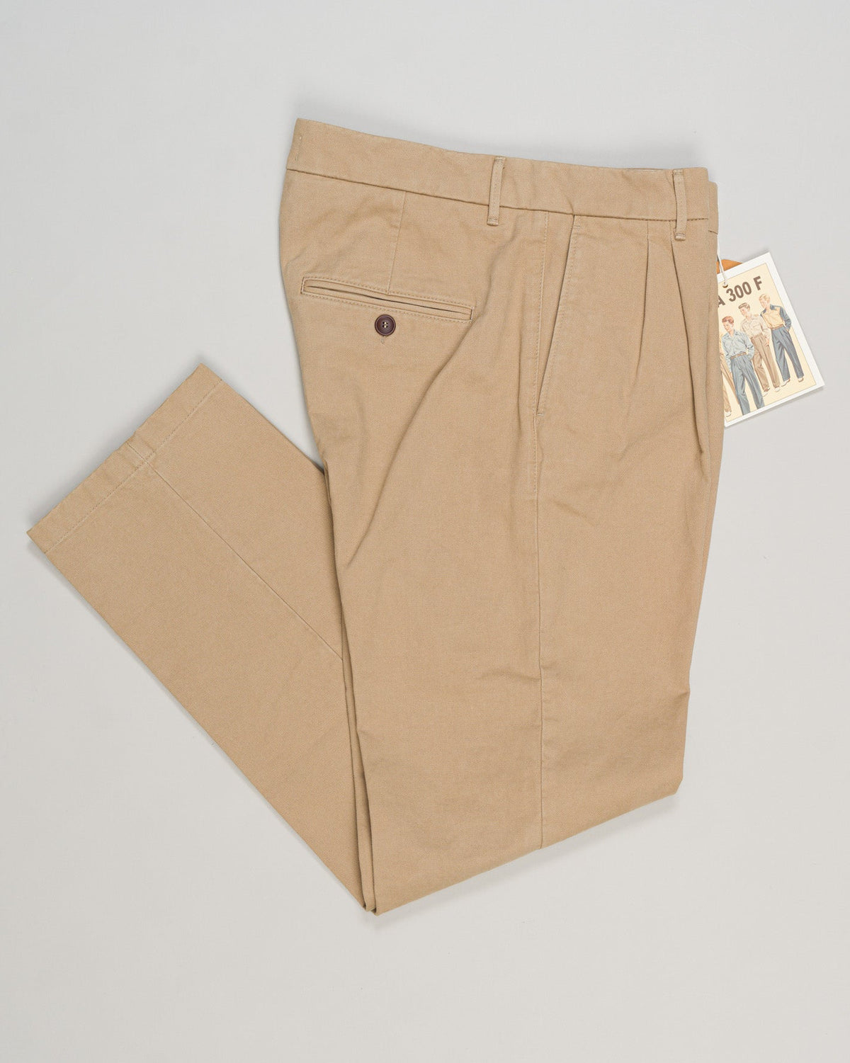 Refined cotton gabardine trousers crafted with precision tailoring. Classic beige tone works seamlessly with knitwear and structured blazers. Flat front with side pockets, finished with a contemporary taper. Ideal for elevated everyday wear and professional settings. Tela Genova Gabardine Trousers / Beige
