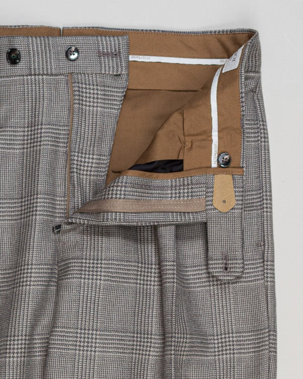 Berwich's Chiaia trousers showcase Italian tailoring heritage with a refined long glencheck pattern in warm greige. Cut with a contemporary silhouette and finished with precision pleating, these trousers balance classic structure with modern sophistication. The carefully selected fabric drapes with quiet elegance, making them an essential foundation for curated menswear wardrobes that demand both substance and understated style.