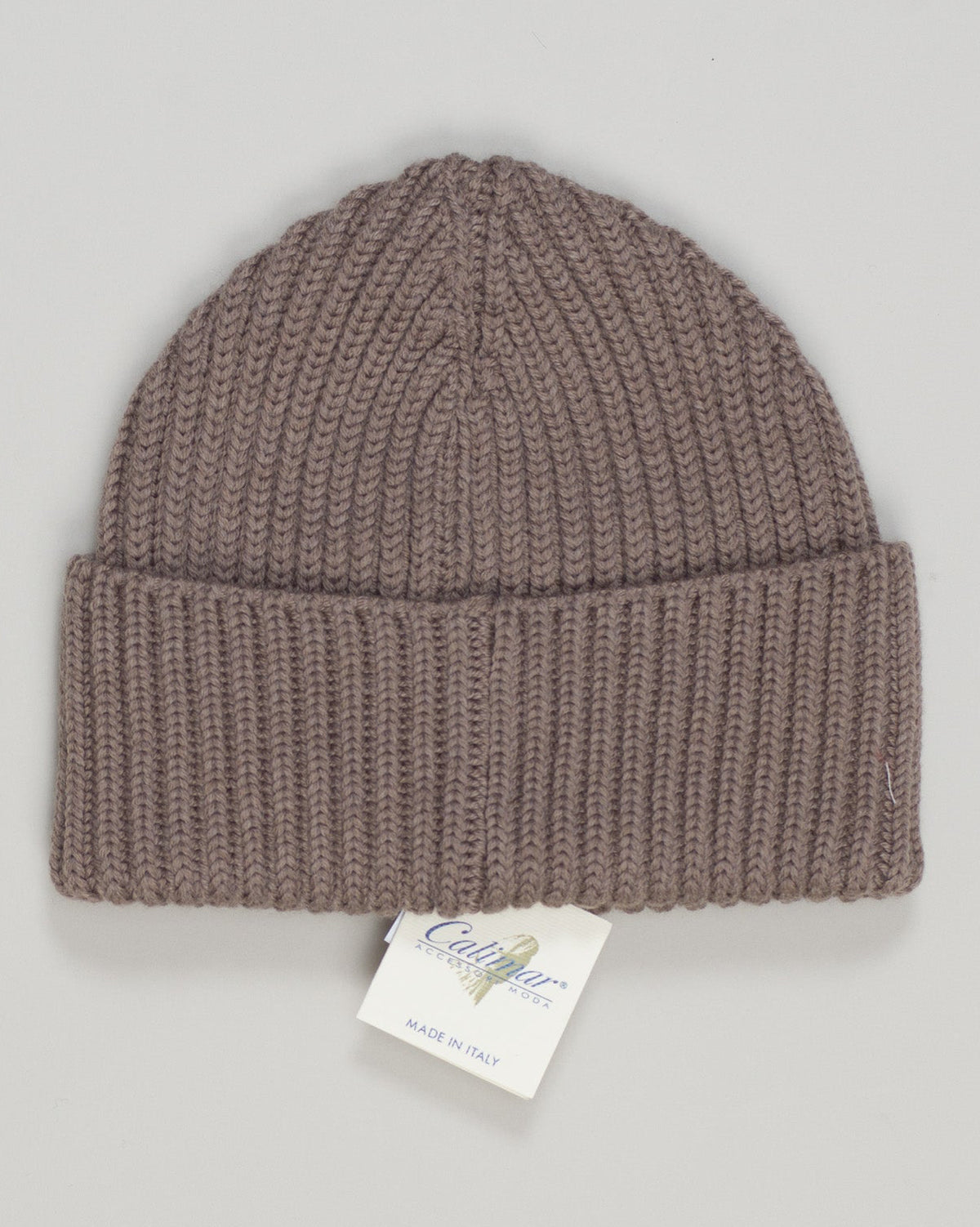Timeless merino wool beanie in a refined taupe tone. The ribbed knit construction offers gentle stretch and durability, while premium merino regulates temperature across seasons. Perfect for everyday wear or as a sophisticated cold-weather essential. Finished with a clean, understated design that complements any wardrobe. Calimar Ribbed Merino Beanie / Taupe