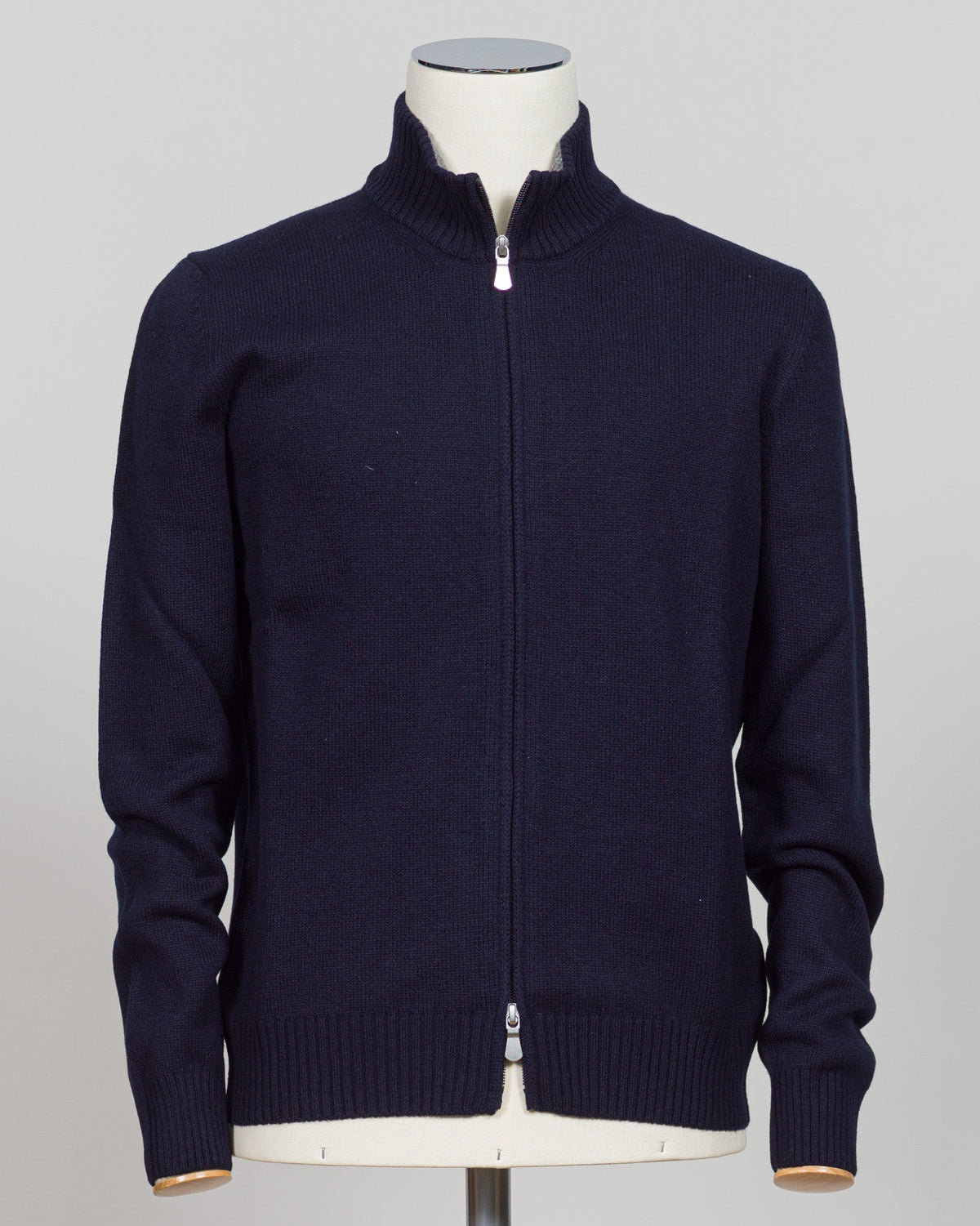 Gran Sasso's full-zip knit is a versatile layering essential crafted from premium Italian yarn. The clean navy colorway pairs effortlessly with tailored trousers or casual wear, while the structured construction ensures a refined silhouette season after season. Designed for those who appreciate quality knitwear without compromise. Gran Sasso Full-Zip Knit / Navy