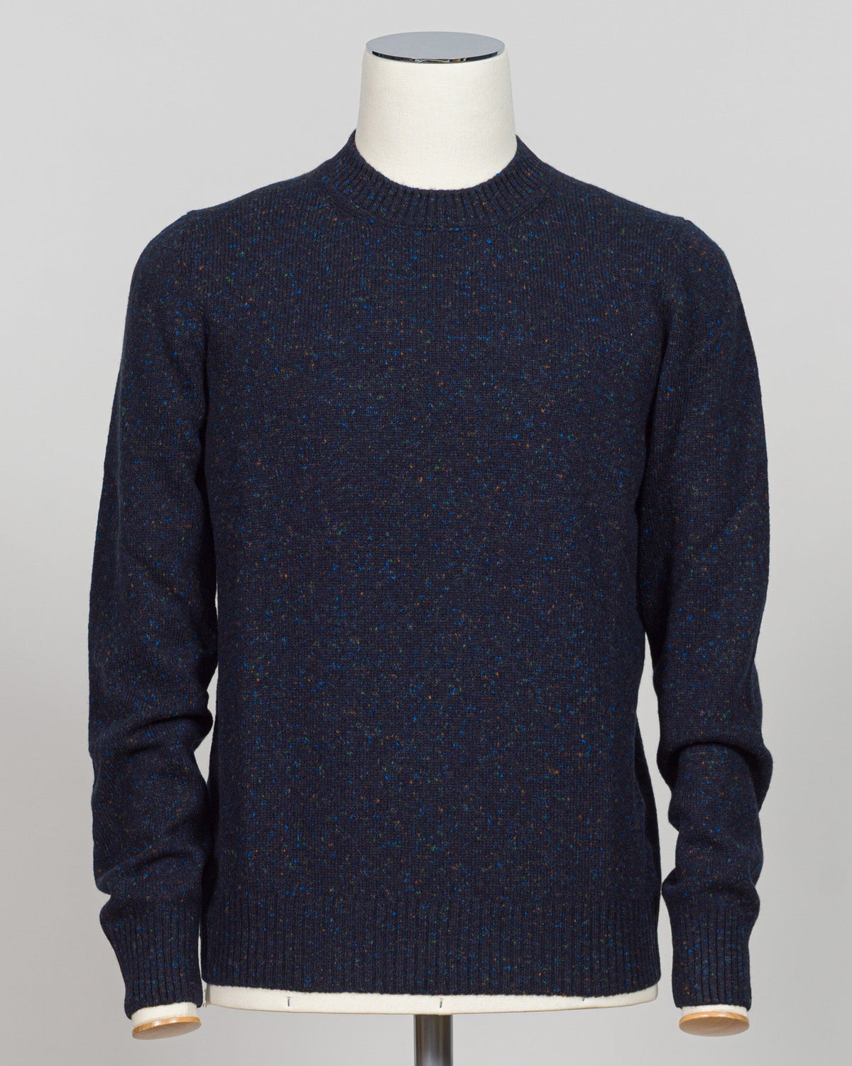 A timeless Donegal knit from Gran Sasso. The textured surface and subtle color variation characteristic of Donegal construction create understated visual interest. Navy grounds this crew neck in versatility—equally at home layered beneath tailored jackets or worn as a refined casual piece. The structured silhouette and quality construction ensure lasting wear. Gran Sasso Donegal Crew Neck / Navy