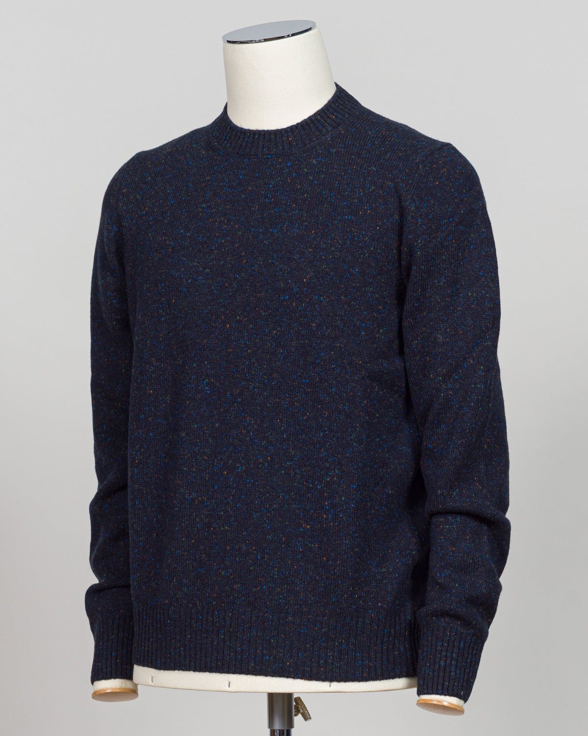 A timeless Donegal knit from Gran Sasso. The textured surface and subtle color variation characteristic of Donegal construction create understated visual interest. Navy grounds this crew neck in versatility—equally at home layered beneath tailored jackets or worn as a refined casual piece. The structured silhouette and quality construction ensure lasting wear. Gran Sasso Donegal Crew Neck / Navy
