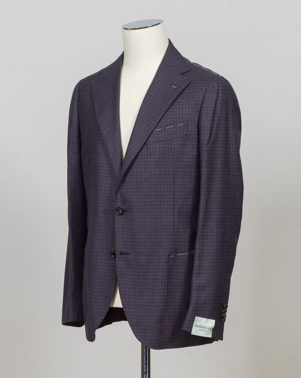 Single breasted
Notch lapel
Two buttons in front
Four sleeve buttons
Welted chest pocket
Patch side pockets
Modello: Sorrento
Hand finished
Half canvas
Half lined
Composition: 74% wool, 17% silk, 9% linen
Article: G201026
Col. Brown and blue
Made in Napoli, Italy Luigi Borrelli Checkered Jacket / Brown & Blue