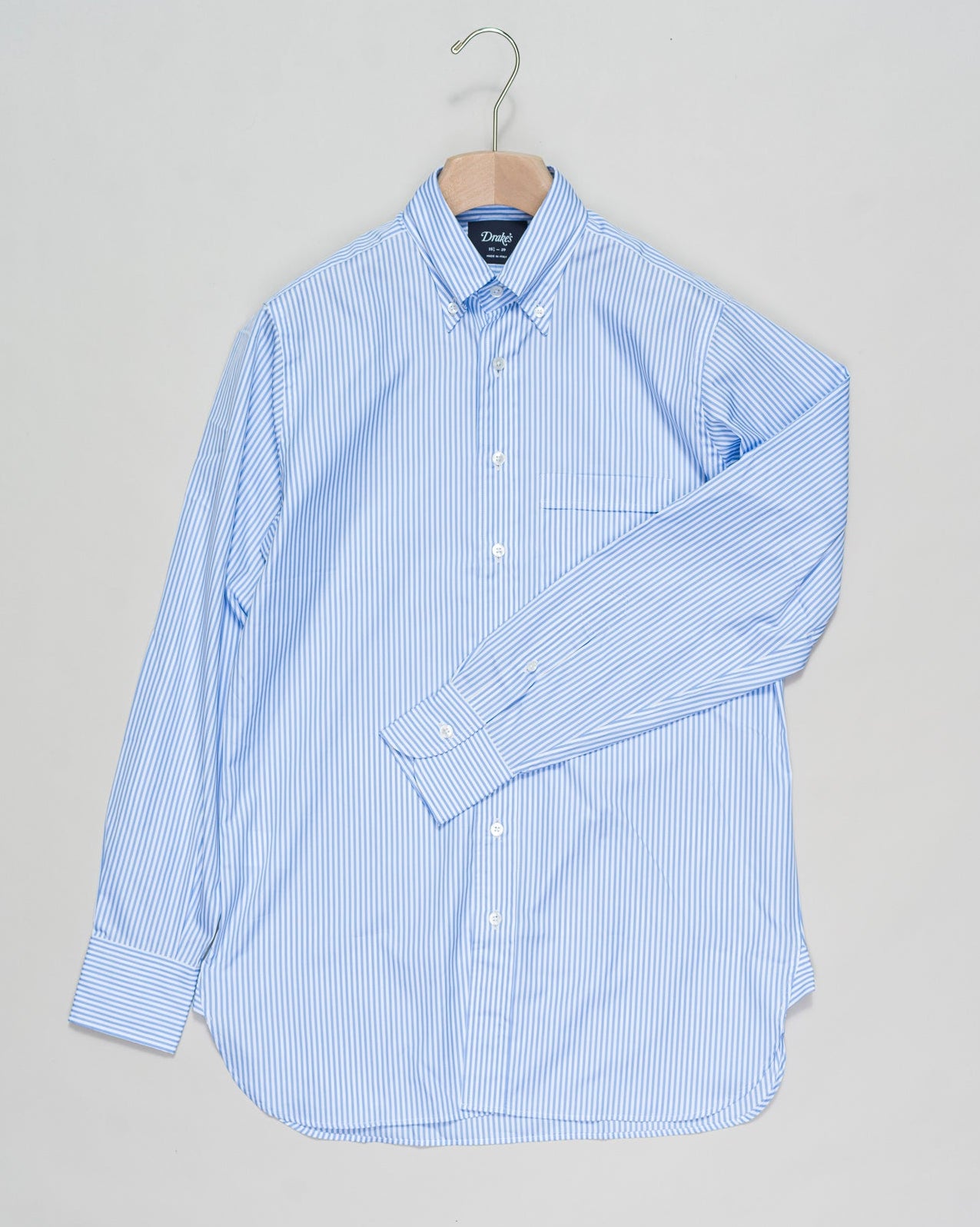 With a regular silhouette, floating interlinings, single-needle construction, and a distinguished button-down collar, it's a shirt for all occasions. Drake's Narrow Stripe Button-Down Poplin Shirt / Sky Blue