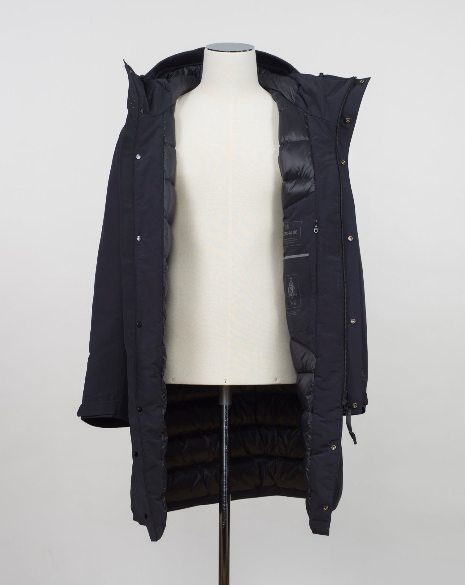 Article: 15CMOW255A 006355A Color: 999 / Black External fabric: 100% Polyester Lining: 100% Polyamide / Nylon Padding (Feather): 90% White duck down, 10% Feather Adjustable hood with logo detail Hidden button and zip fastening Breathable armpit ventilation Taped shoulder seams Storm flap Internal pocket Angular hand pockets Adjustable waist and cuffs Printed logo detail on left sleeve