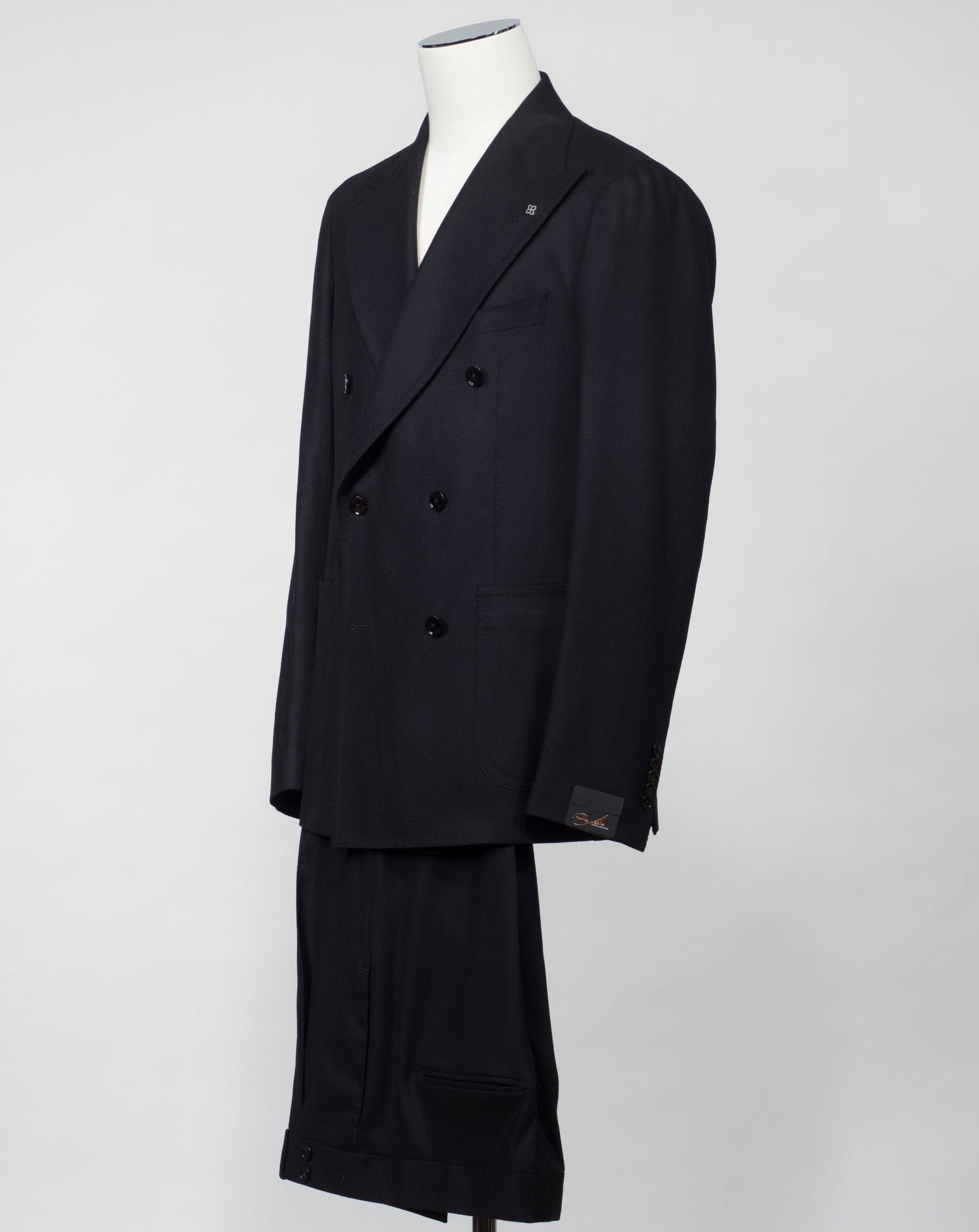 Composition: 99% Virgin Wool Super 100's 1% Elastan stretch Modello: A-PL20KBR AI Color: Black / N3438 Unconstructed Unlined Double-breasted Wide peak lapel Patch pockets Side vents One pleat Made in Martina Franca, Italy Tagliatore Double-Breasted Flannel Suit / Black