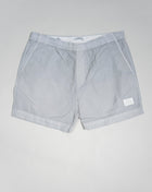 Eco-Chrome swim shorts constructed with an elasticated drawstring waist, hand pockets and a logo detail. Chrome is C.P. Company’s foundation woven multifilament nylon. This new version uses Econyl® regenerated nylon yarns, created through the upcycling of fishing nets.  Art.  BW005A 6369G Col.  936 Light Gray Elasticated drawstring waist Hand pockets Logo detail Nylon dyed