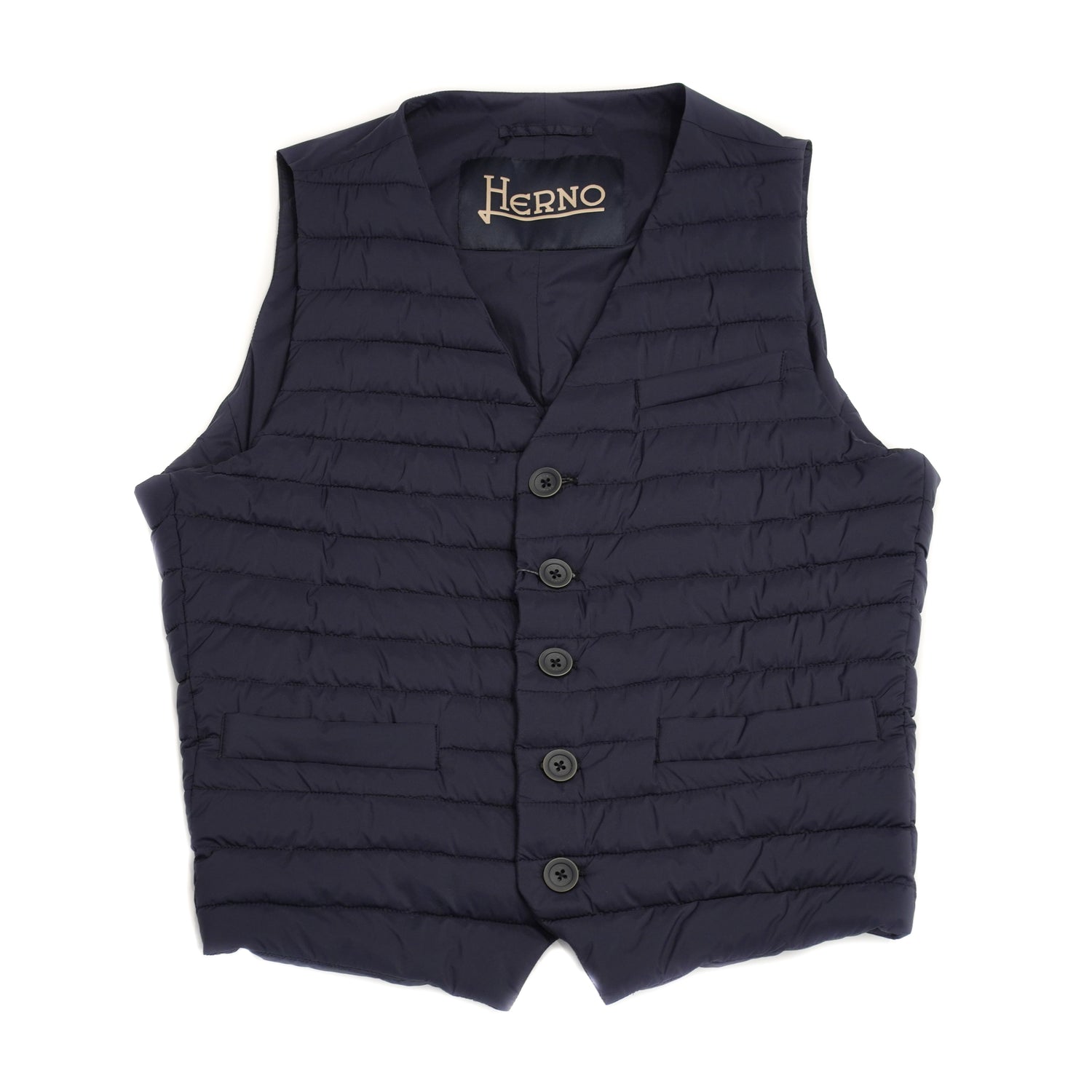 Herno In-Tech™ Alternative Down Waistcoat in Blue. Great piece for layering.A true must have for every modern gentleman. Wear it under jacket or over a knit. Great for traveling as it packs small and weighs almost nothing. In-Tech™ Alternative Down Water Repellent Breathable Light Insulation 5 buttons 3 pockets Adjustable back External layer 100% Polyamide Internal padding 100% Polyester PC0039U 19288 9201 Made in Romania