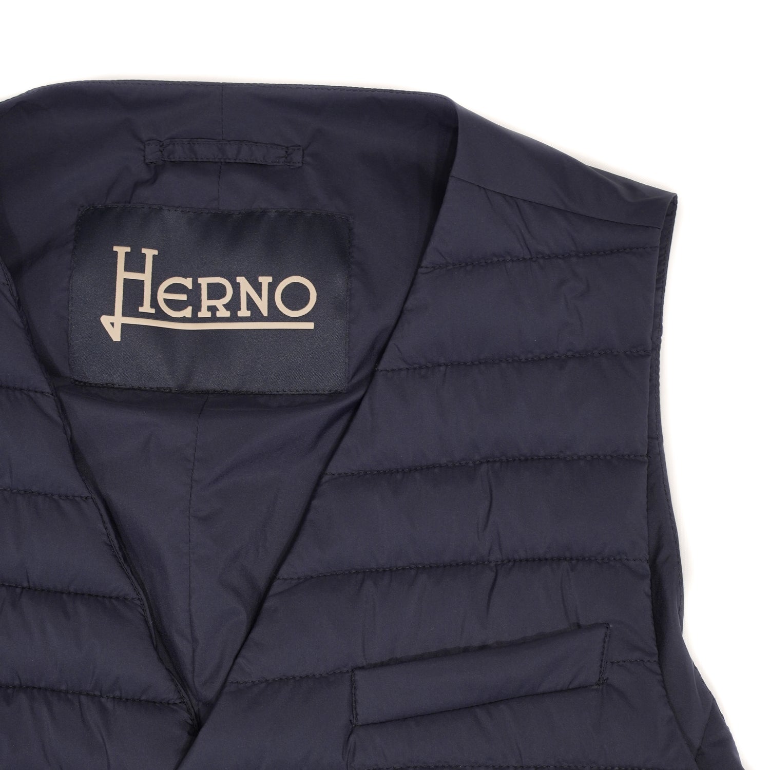 Herno In-Tech™ Alternative Down Waistcoat in Blue. Great piece for layering.A true must have for every modern gentleman. Wear it under jacket or over a knit. Great for traveling as it packs small and weighs almost nothing. In-Tech™ Alternative Down Water Repellent Breathable Light Insulation 5 buttons 3 pockets Adjustable back External layer 100% Polyamide Internal padding 100% Polyester PC0039U 19288 9201 Made in Romania