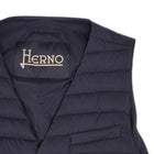 Herno In-Tech™ Alternative Down Waistcoat in Blue. Great piece for layering.A true must have for every modern gentleman. Wear it under jacket or over a knit. Great for traveling as it packs small and weighs almost nothing. In-Tech™ Alternative Down Water Repellent Breathable Light Insulation 5 buttons 3 pockets Adjustable back External layer 100% Polyamide Internal padding 100% Polyester PC0039U 19288 9201 Made in Romania