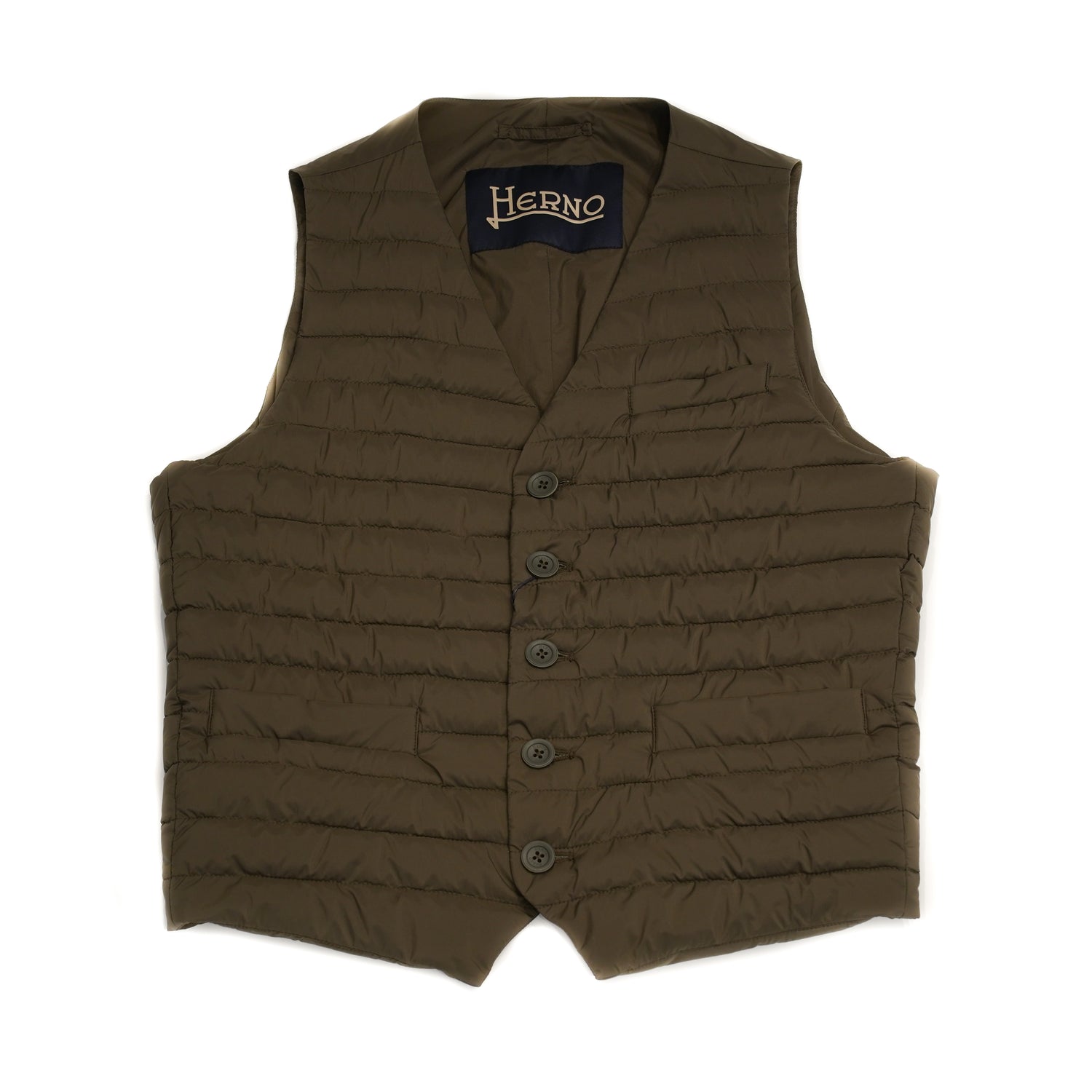 Herno In-Tech™ Alternative Down Waistcoat in Green. Great piece for layering.A true must have for every modern gentleman. Wear it under jacket or over a knit. Great for traveling as it packs small and weighs almost nothing. In-Tech™ Alternative Down Water Repellent Breathable Light Insulation 5 buttons 3 pockets Adjustable back External layer 100% Polyamide Internal padding 100% Polyester PC0039U 19288 7745 Made in Romania