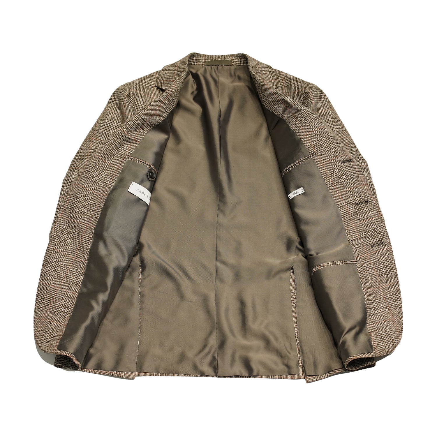 Caruso Aida jacket. Light brown glencheck pattern highlighted with delicate red over check. Wool,silk linen Caruso represents the highest tailoring traditions Italy. handmade full canvas structure inside. * Wool/SIlk/Linen mix summer jacket * Fully lined * Unconstructed shoulder * 3 roll 2 buttoning * Side vents * Notch lapel * Patch pockets * Composition: 48% wool, 24% silk, 28% linen * Color: Light brown * Modello: Aida / ASM2JM304F * Article: 504541 * Colore: 0560 * Made in Italy