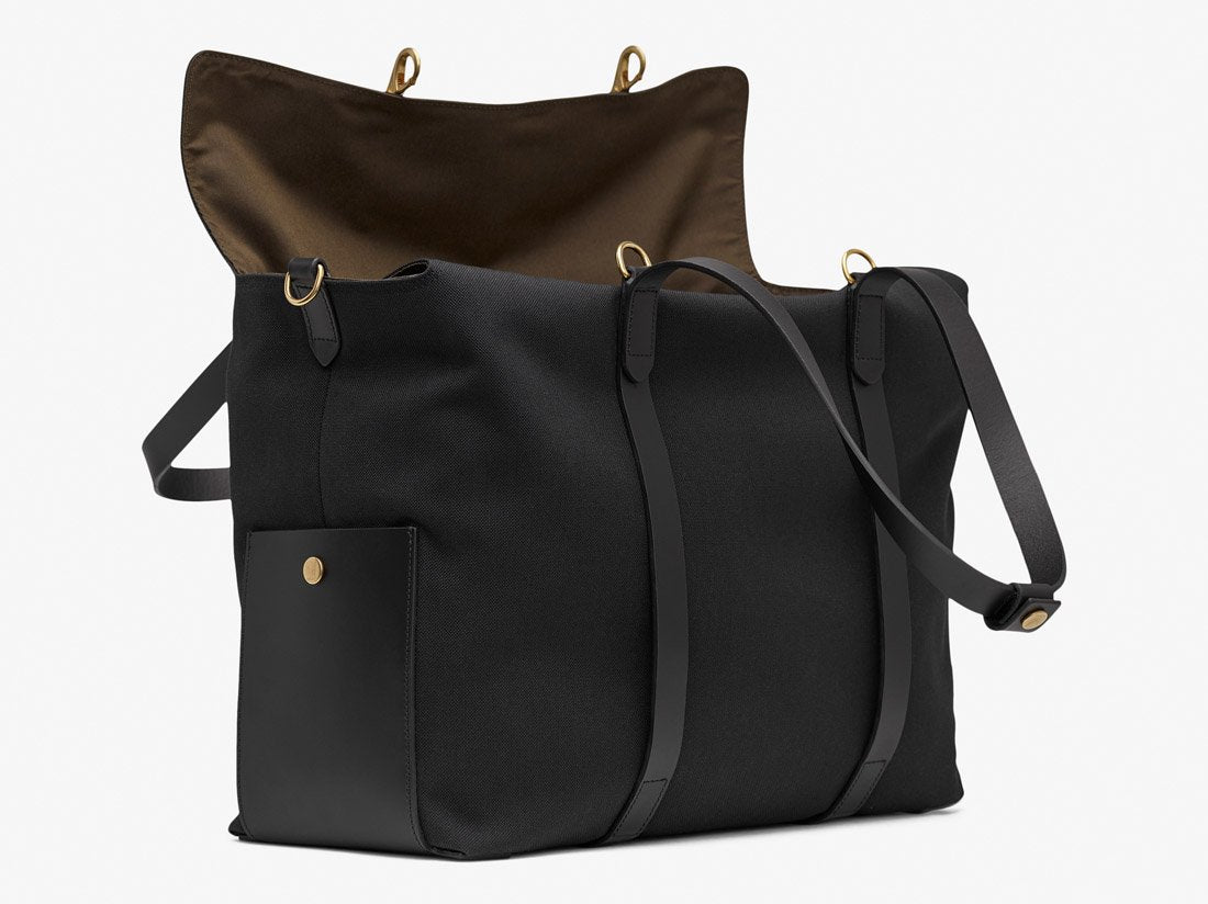 Measurements: L: 46 H: 34 W:18 cm Body: Water-repellent cotton and nylon blended canvas Fabric Comp.: PA 47% PL 20% CO 20% PC 6% PU 7% / 812 gr./rm. Trimmings: Black vegetable tanned full-grain bridle leather Lining: 100% cotton in Army colour Hardware: Solid brass w. varnish protection Zipper: Hand Polished YKK Excella Art No. MS116418 travel bag, or bend flaps down for a large, open city tote bag. A full-grain leather pocket on each gusset adds extra durability to the bottom corners.