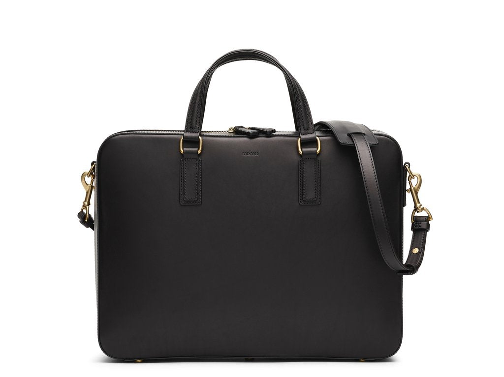 Measurements: L: 39 H: 29 W: 8,5cm Body: Vegetable tanned full-grain cow leather Leather trimmings: Vegetable tanned full-grain cow leather Hardware: Polished ZAMAK Hooks - Golden Lining: Cotton/nylon stripe lining - Off white/anthracite Zippers: Hand-polished YKK Excella Art. No. FG010118 briefcase in a design kept as clean as possible to allow the vegetable full-grain leather to really shine. Features a signature zipper opening that runs from bottom to bottom