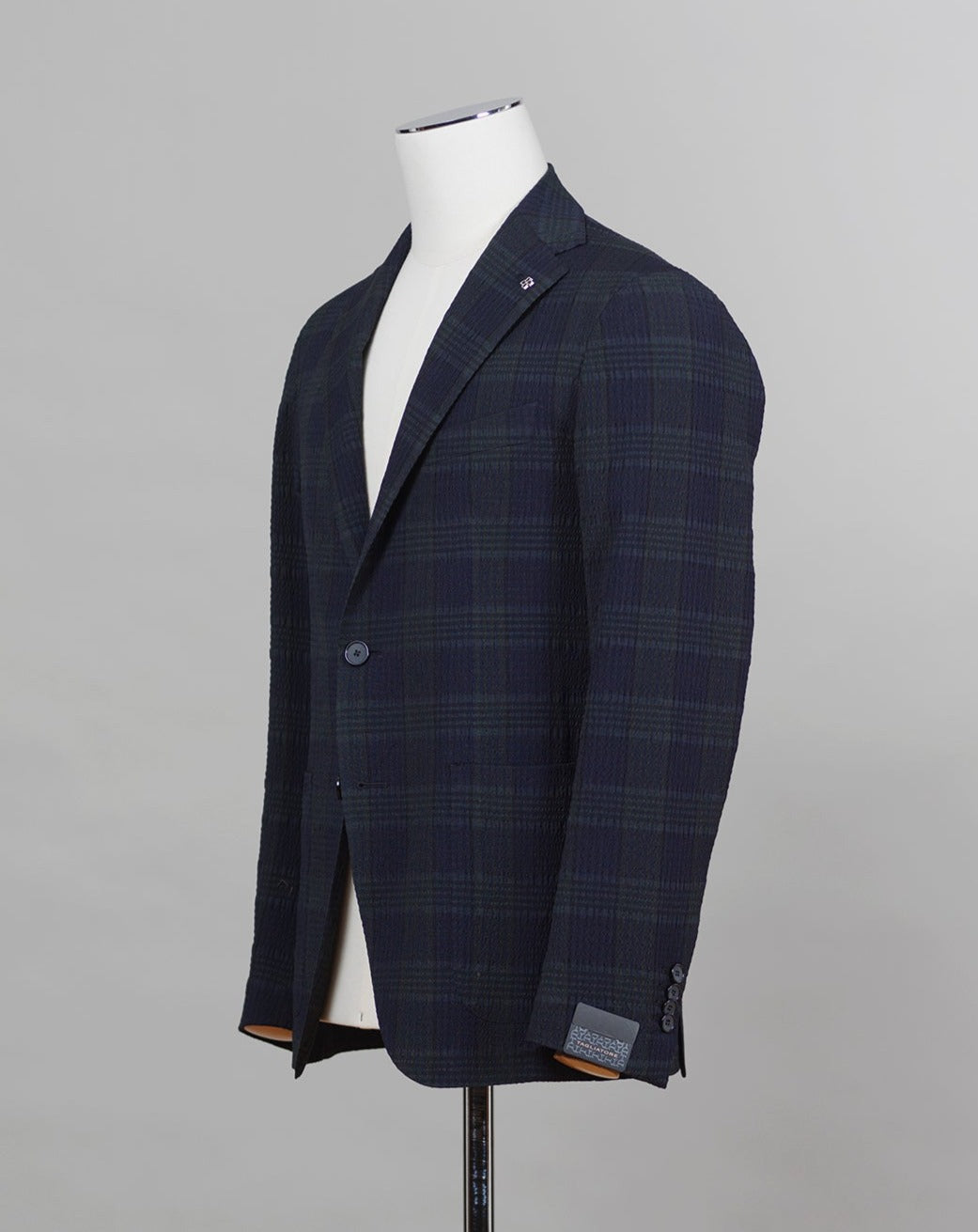 Tagliatore jacket made from a Black Watch seersucker fabric. The weave of seersucker fabric gives it a distinctive gentle wrinkled look. This come with a purpose. The wrinkles