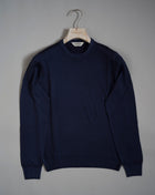 Gran Sasso Vintage merino wool knit. It has been garment dyed to achieve nice vintage look. This means it has more vivid compared to yarn dyed knitwear.   Vintage Merino is a core quality in our Gran Sasso collection. We offer a lighter quality for spring/summer and heavier for autumn/ winter season.   Crew neck 100% merino wool Vintage washed (garment dyed) Ribbed hem and cuffs Fashion fit Article: 55167/22792 Colore:   905 / Navy Made in Italy